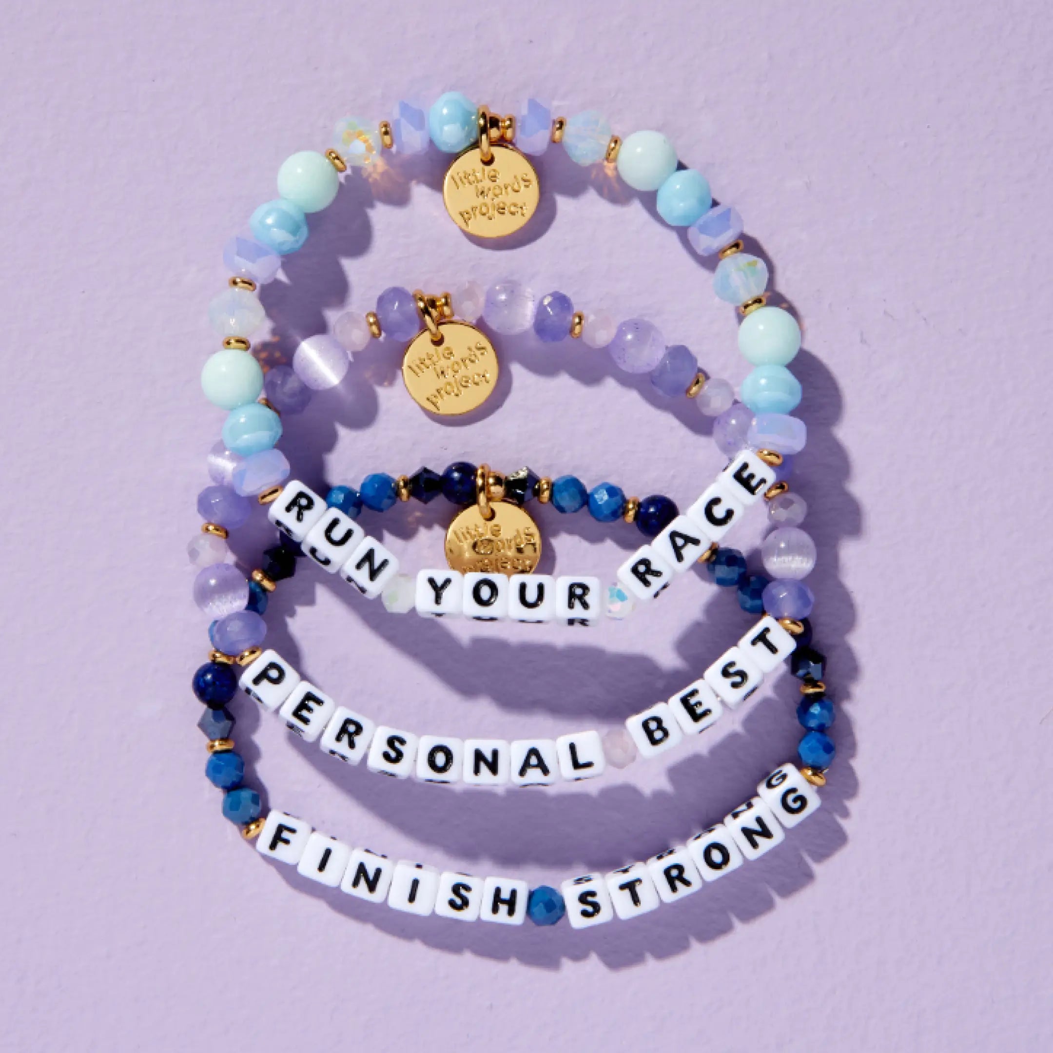 Little Words Project Global Run Day bracelet and charm collection, group flat-lay