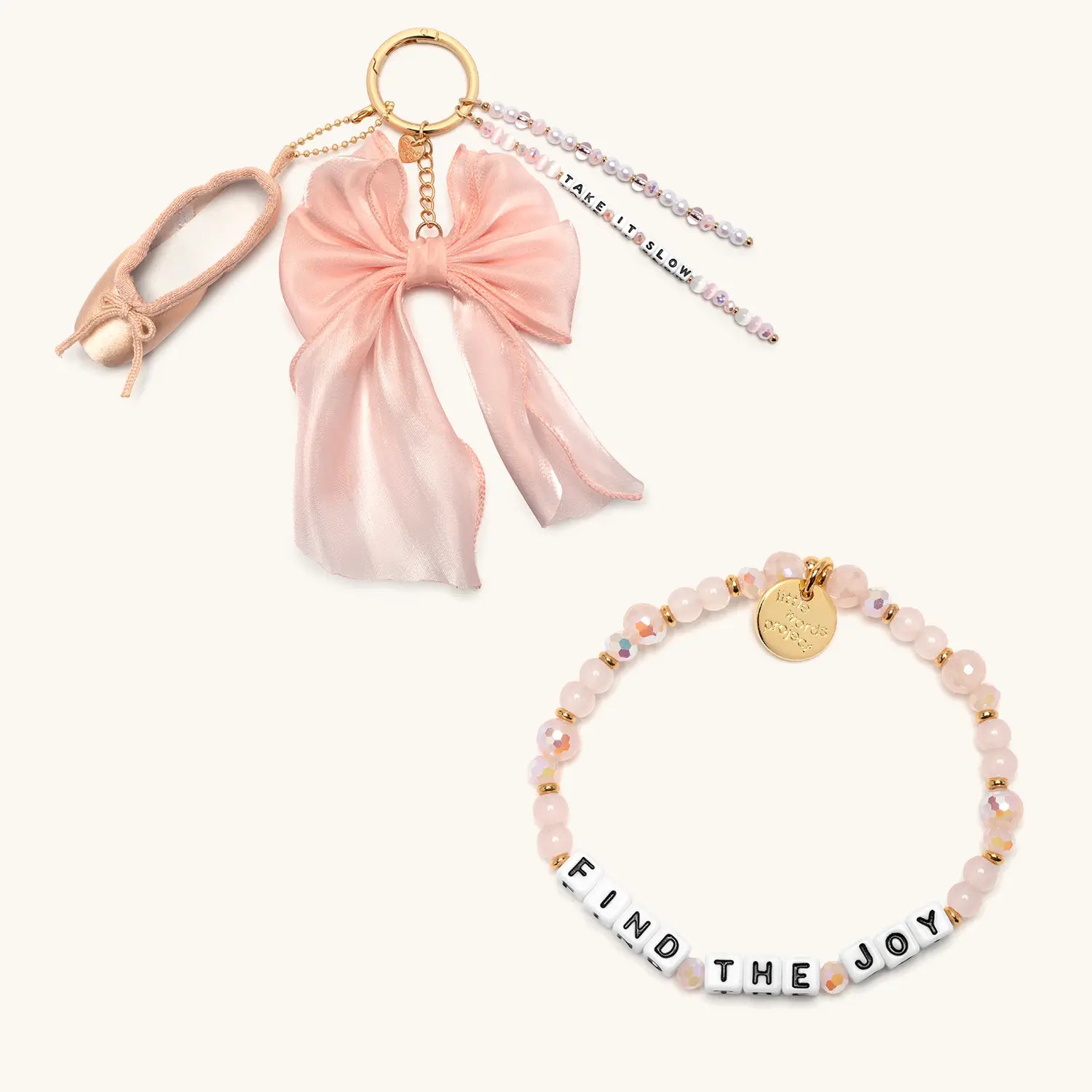 Take It Slow Set with Find The Joy pink bracelet and satin bow bag charm, flat lay