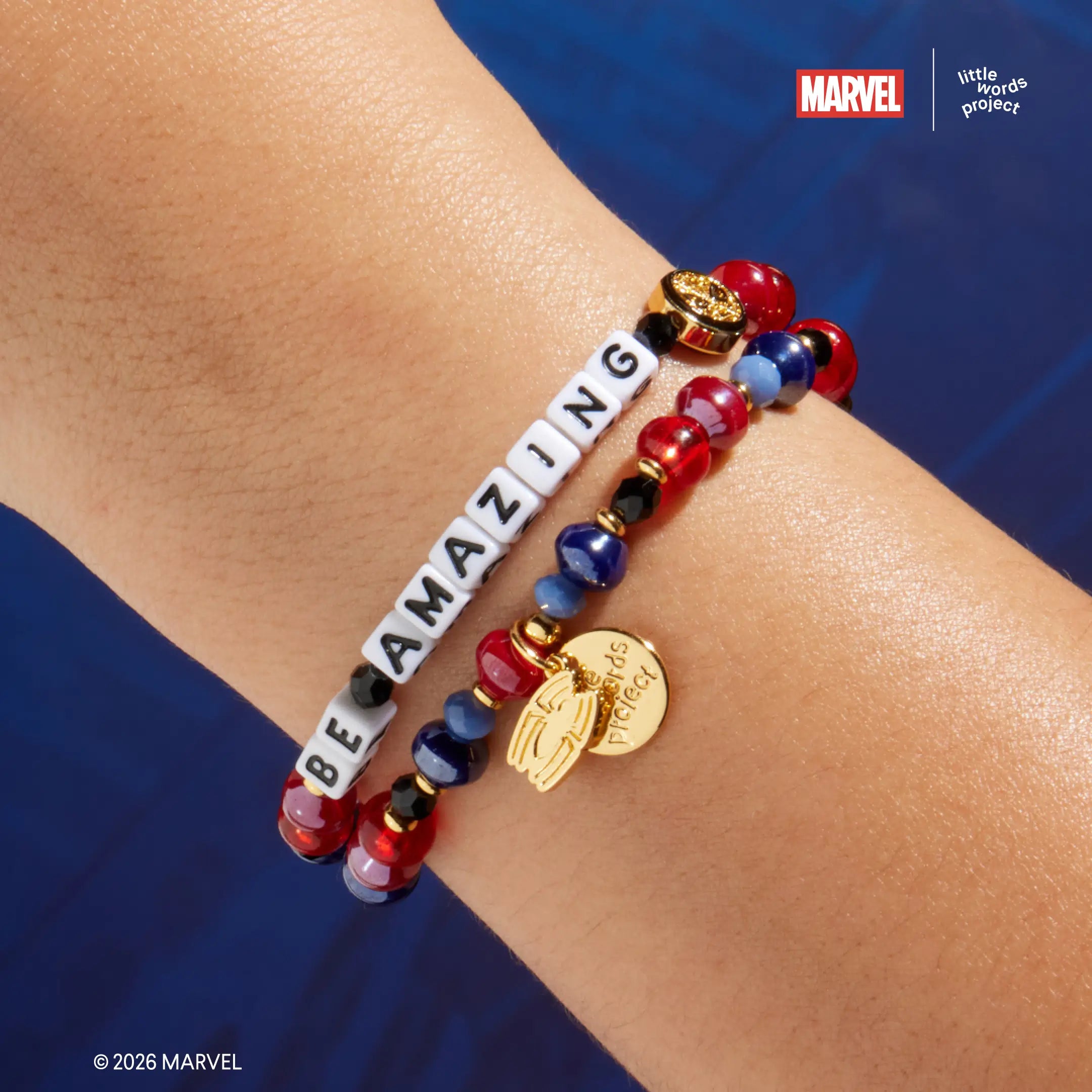 Be Amazing bracelet from Marvel's Spider-Man collection worn on wrist, on-model close-up showing red, navy blue, and black glass beads with gold Spider-Man casted bead