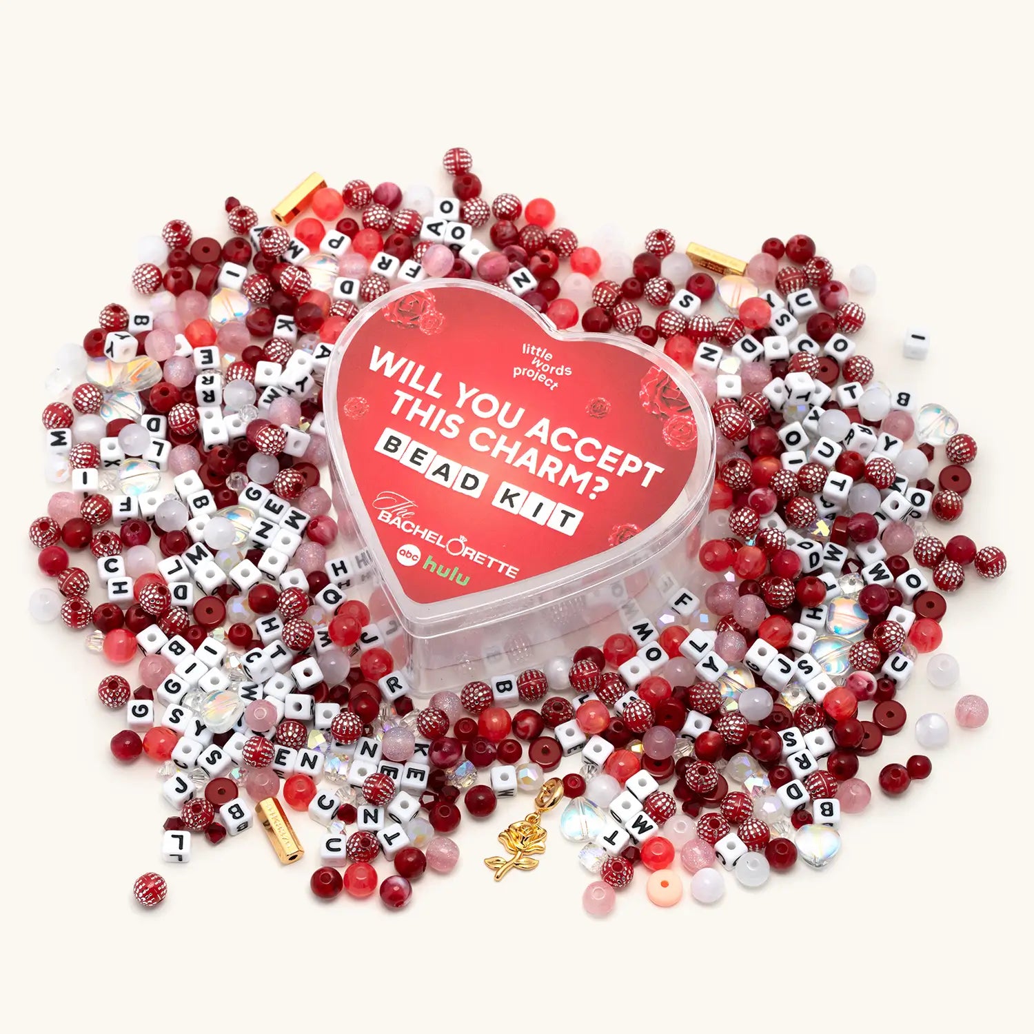 Bead kit with red, white, and black beads and a heart-shaped container on a white background