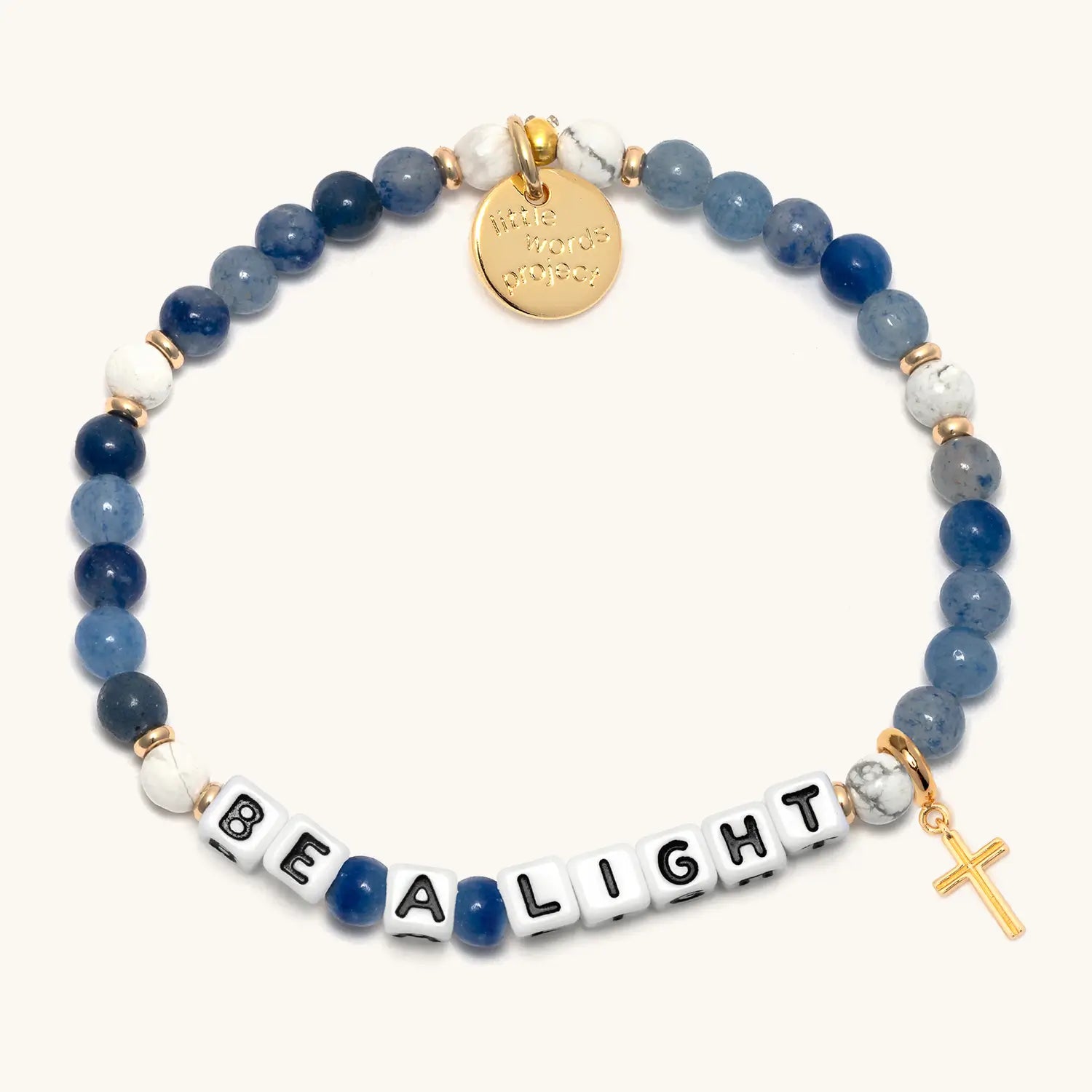Bracelet with blue and white beads, gold charm, and 'Be A Light' message on a white background