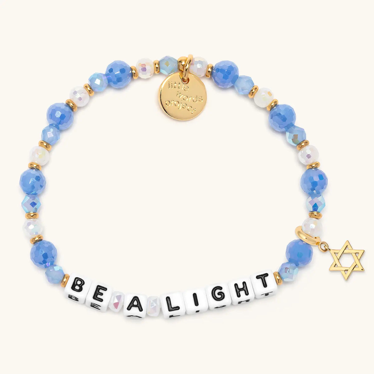 Be a Light bracelet in the Blizzard Baby bead pattern with white letter beads, gold Star of David charm, flat-lay on cream background