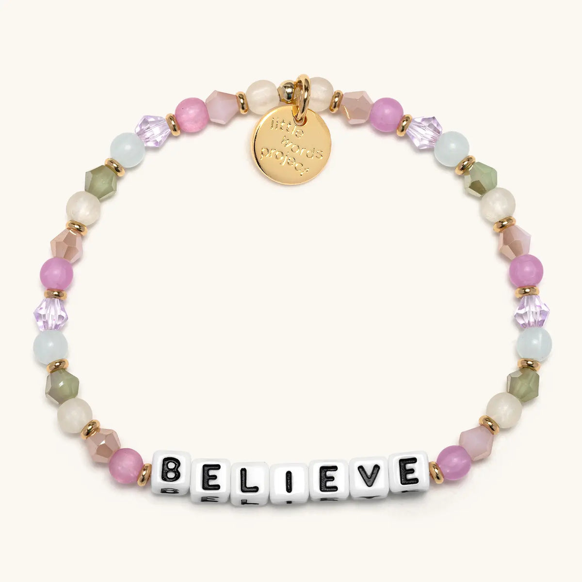 Believe bracelet with white letter beads from the Good Things Ahead Bracelet Set, flat-lay on cream background