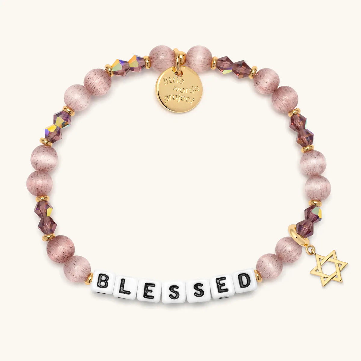 Blessed bracelet in the Holiday Spritz bead pattern with white letter beads, gold Star of David charm, flat-lay on cream background