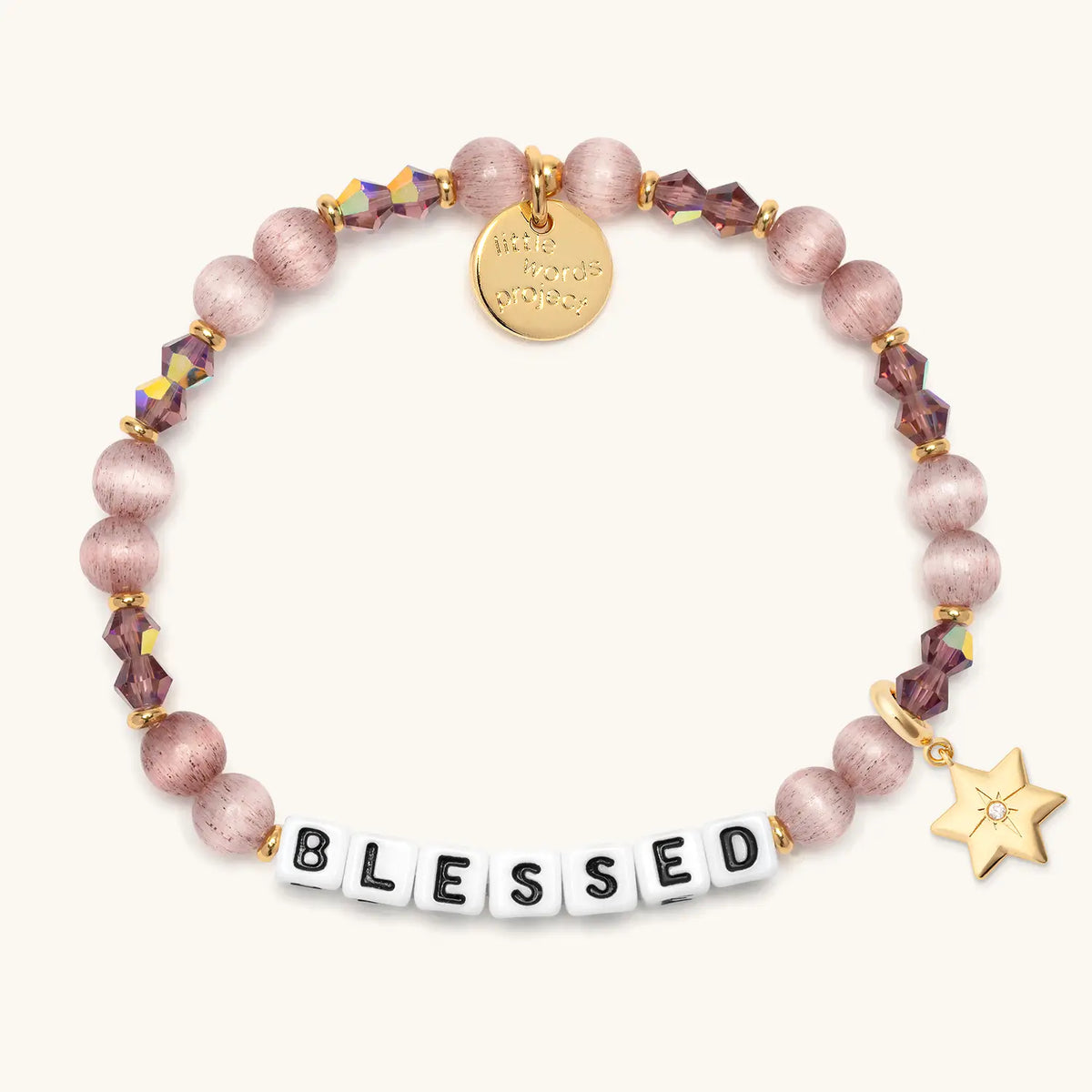 Blessed bracelet in the Holiday Spritz bead pattern with white letter beads, gold puffy Star of David charm with a clear CZ stone, flat-lay on cream background