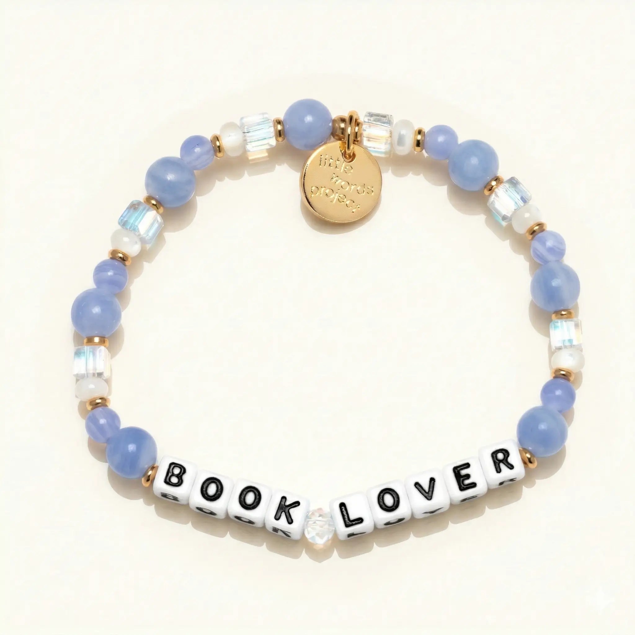 Bracelet with blue beads and 'BOOK LOVER' on a white background
