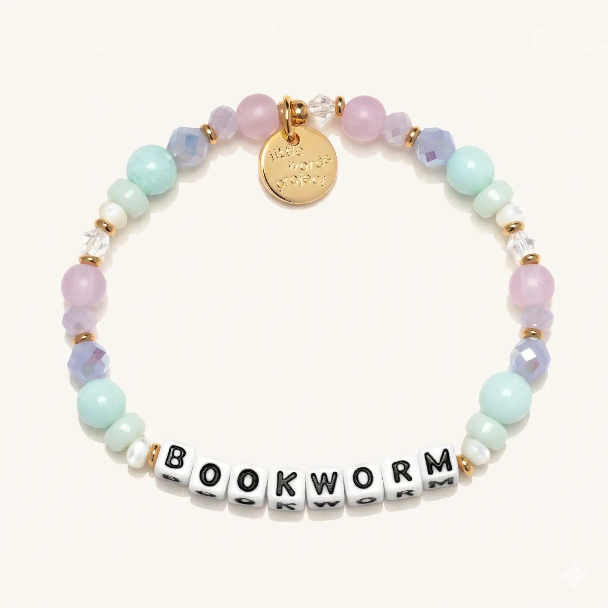 Bracelet with pastel beads and 'BOOKWORM' charm on a white background