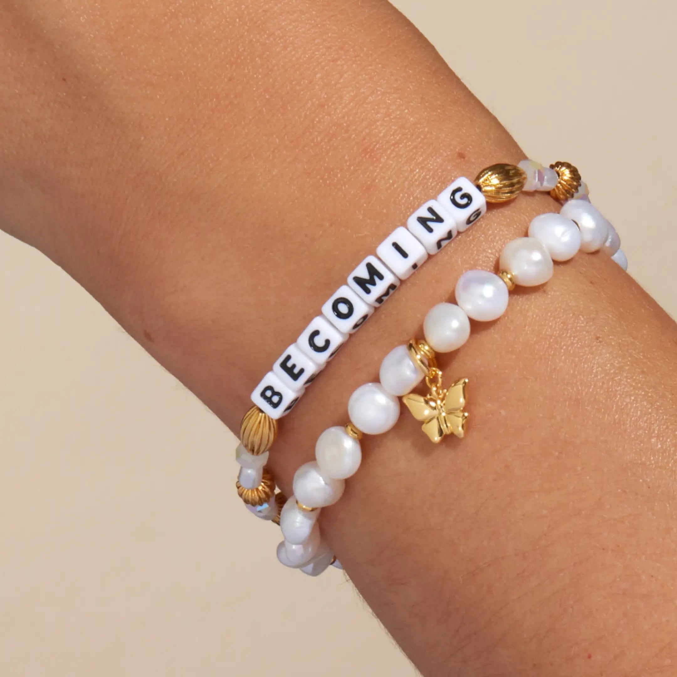 Becoming Bracelet Set- Nika Diwa on-model wrist shot, Becoming bracelet and Butterfly Pearl Bracelet Base stacked on wrist