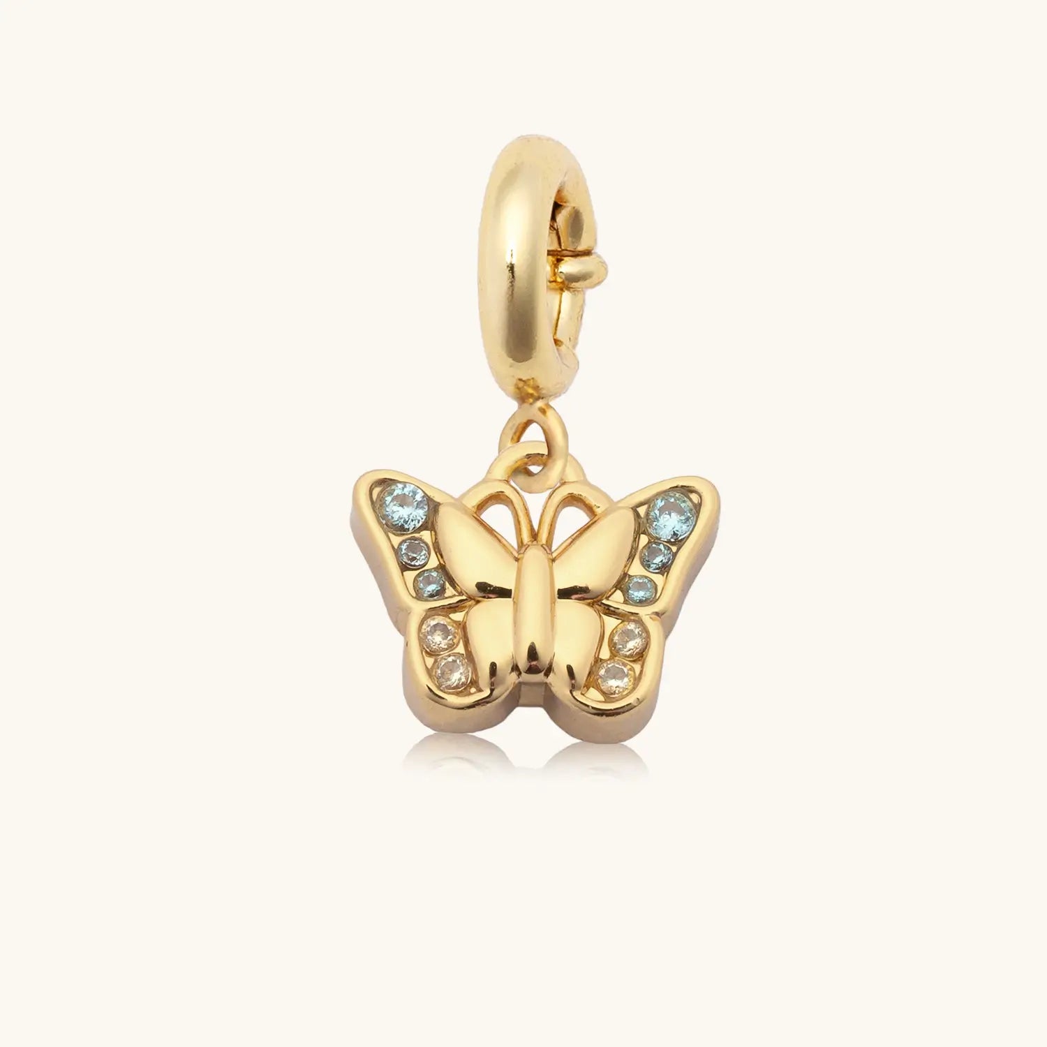 Gem Stone Butterfly gold plated charm with blue cubic zirconia detail, flat lay