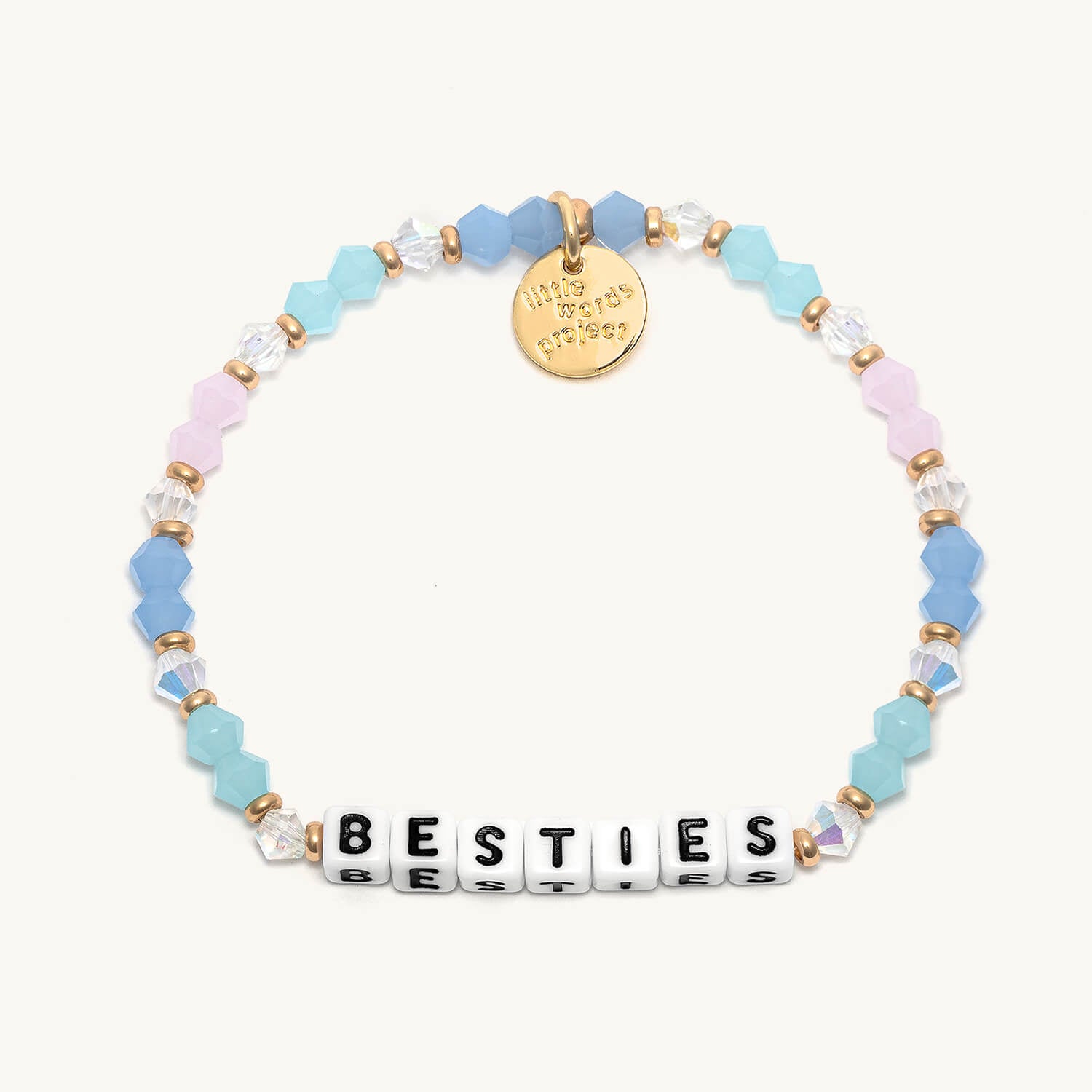 A beaded bracelet with the word 'BESTIES' written on it, featuring a mix of blue, pink, and clear beads, with a gold-colored tag.