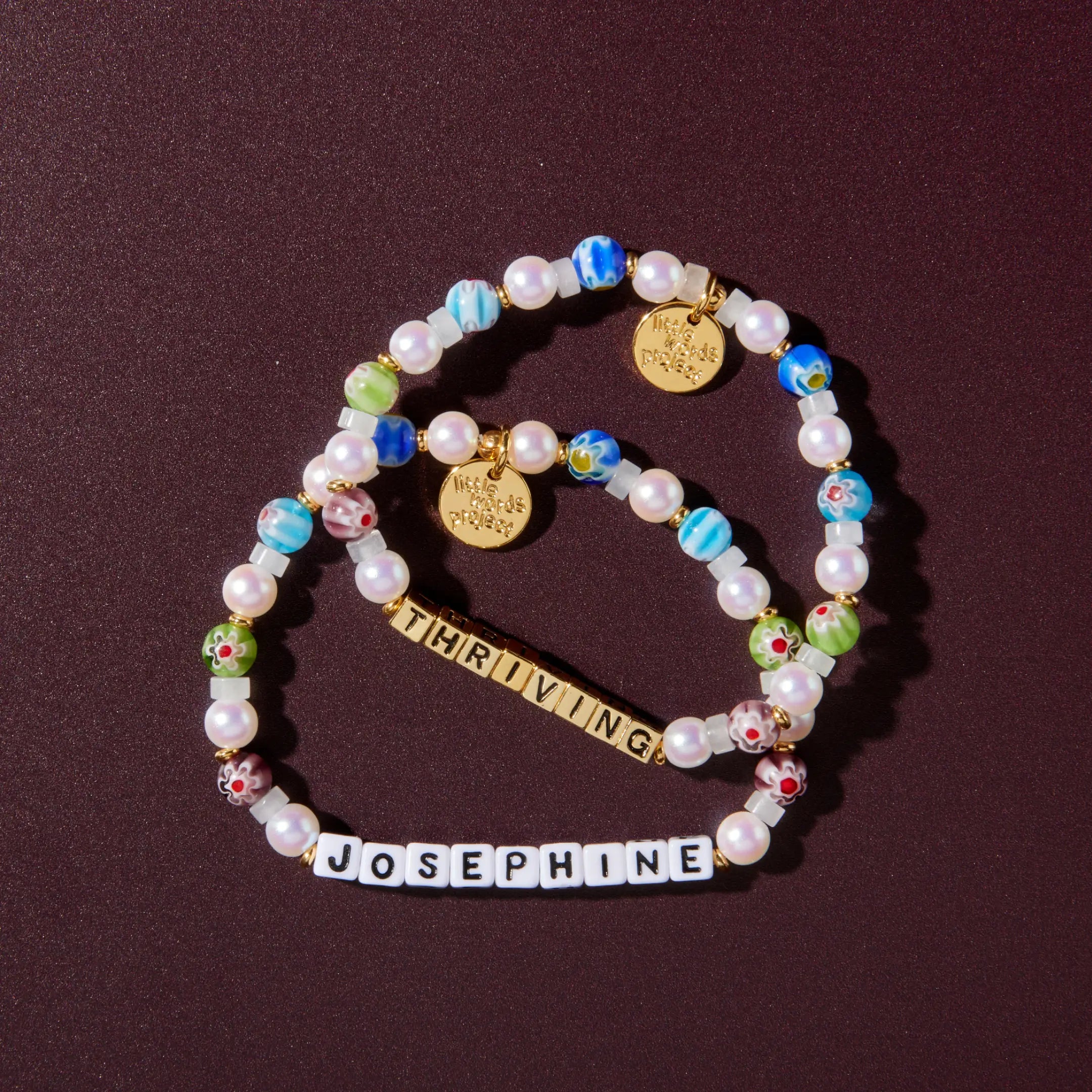 Two beaded bracelets on a dark background
