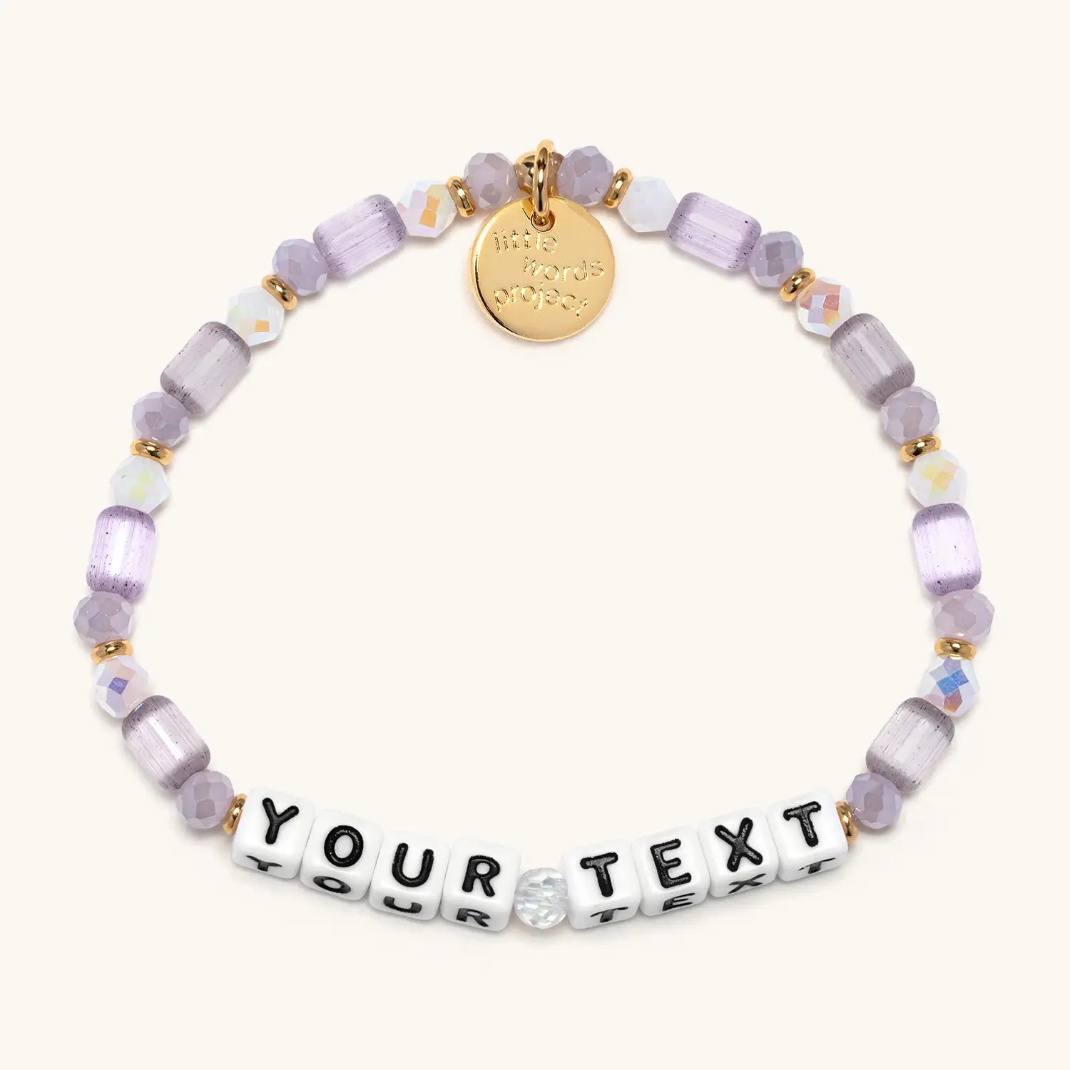 Personalized bracelet with purple beads and letter tiles on a white background