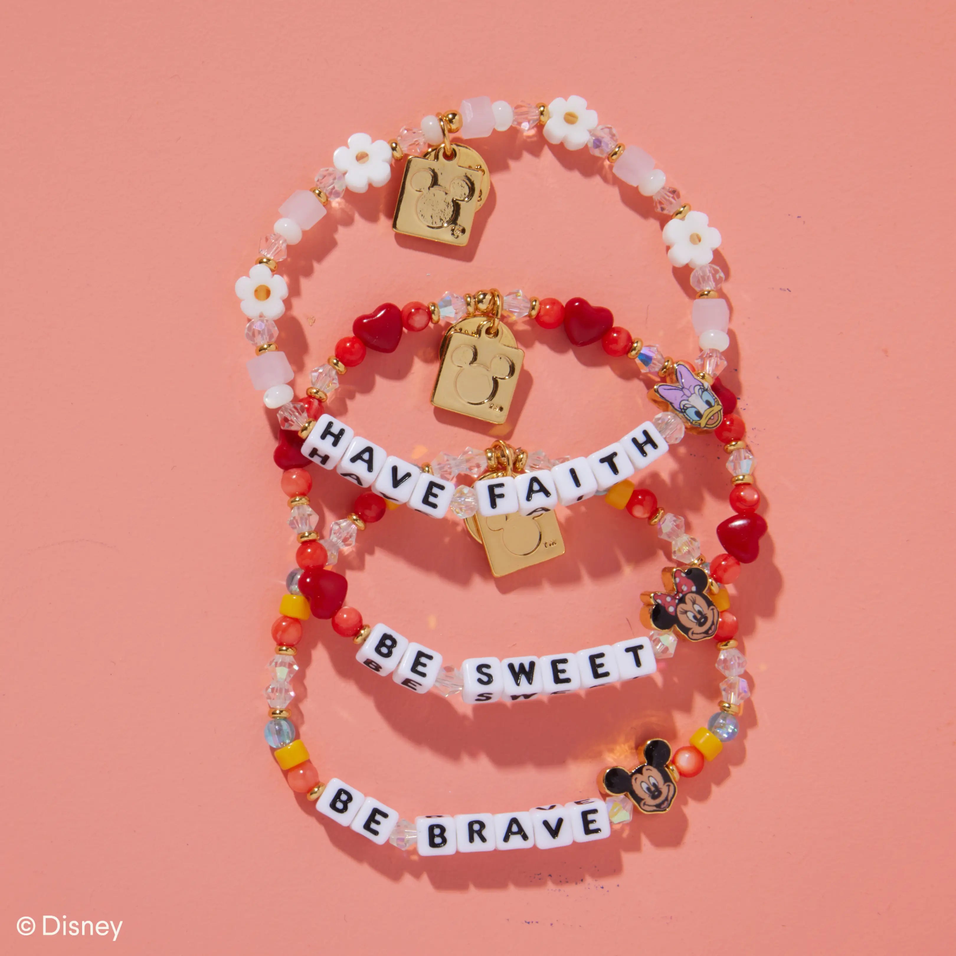 Decorative bracelet with motivational phrases on a pink background