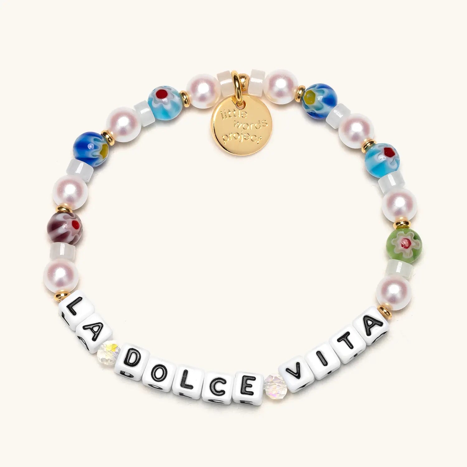 Bracelet with 'La Dolce Vita' and a gold tag on a white background