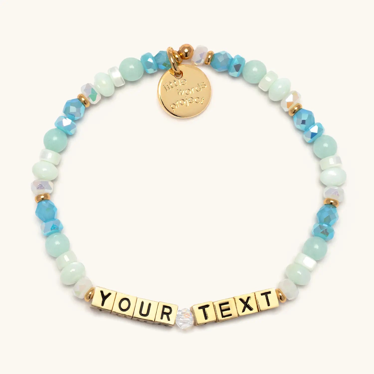 Custom Divine Favor bracelet — gold letter beads on gold chain, flat-lay