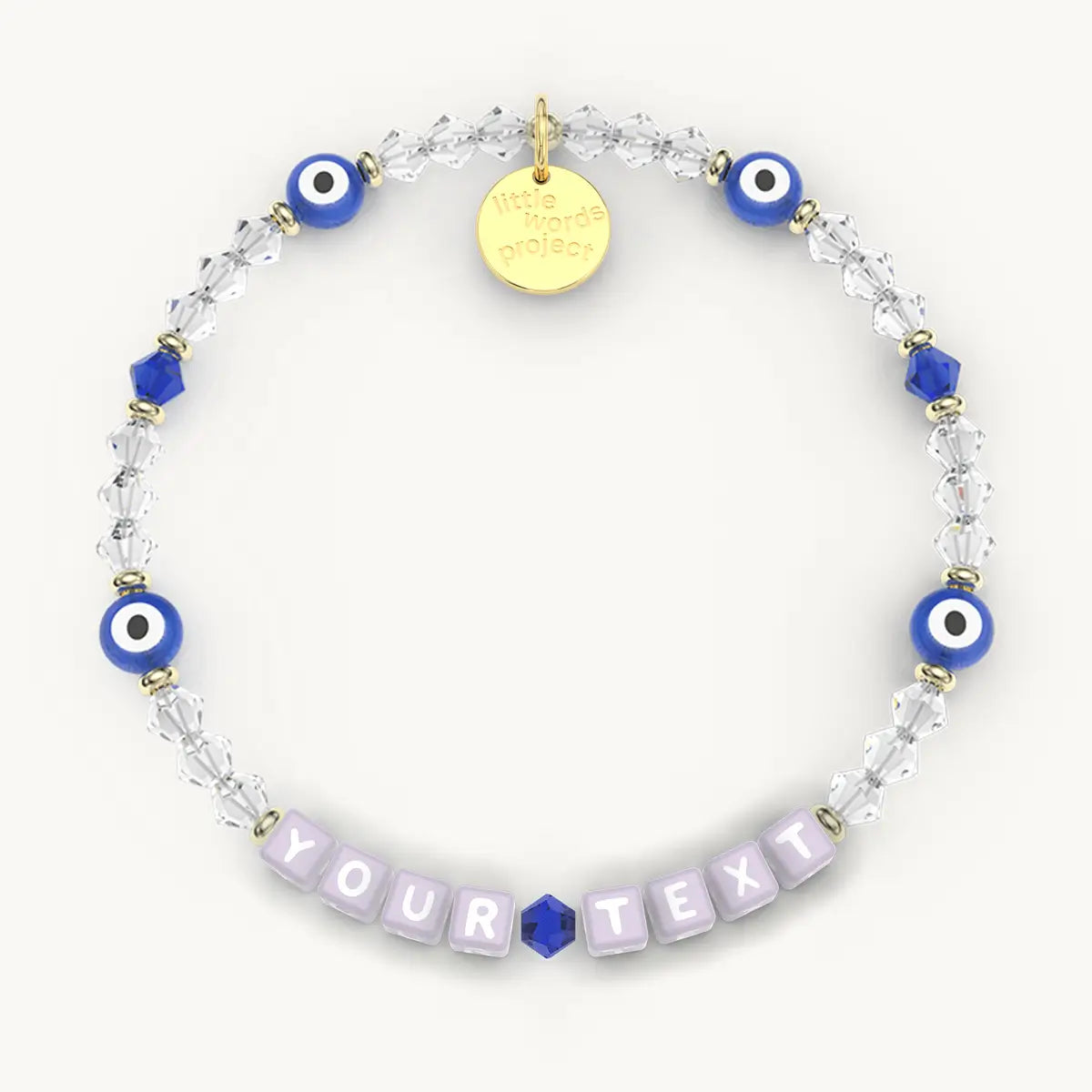 Bracelet with blue evil eye beads and a gold tag on a white background