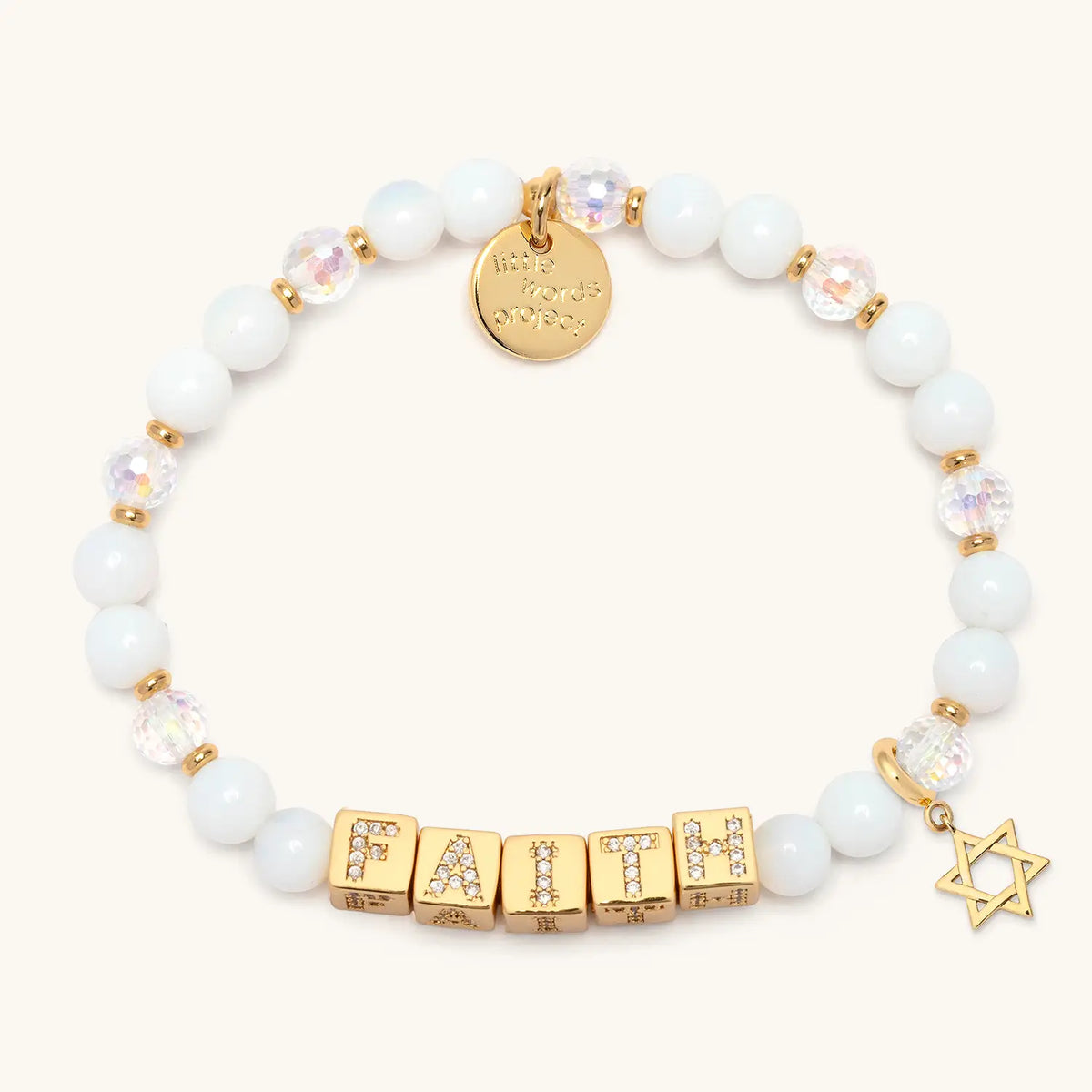 BOLDER Faith Bracelet in the Icicle Energy bead pattern with gold CZ letter blocks, gold Star of David charm, flat-lay on cream background