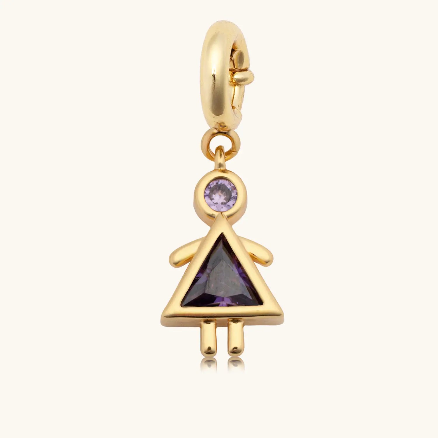 A gold dangle charm in the shape of a girl figure, featuring a round blue gemstone as the head and a triangular dark purple gemstone as the body forming a dress silhouette, with gold arms and legs, attached to a gold spring-ring clasp.