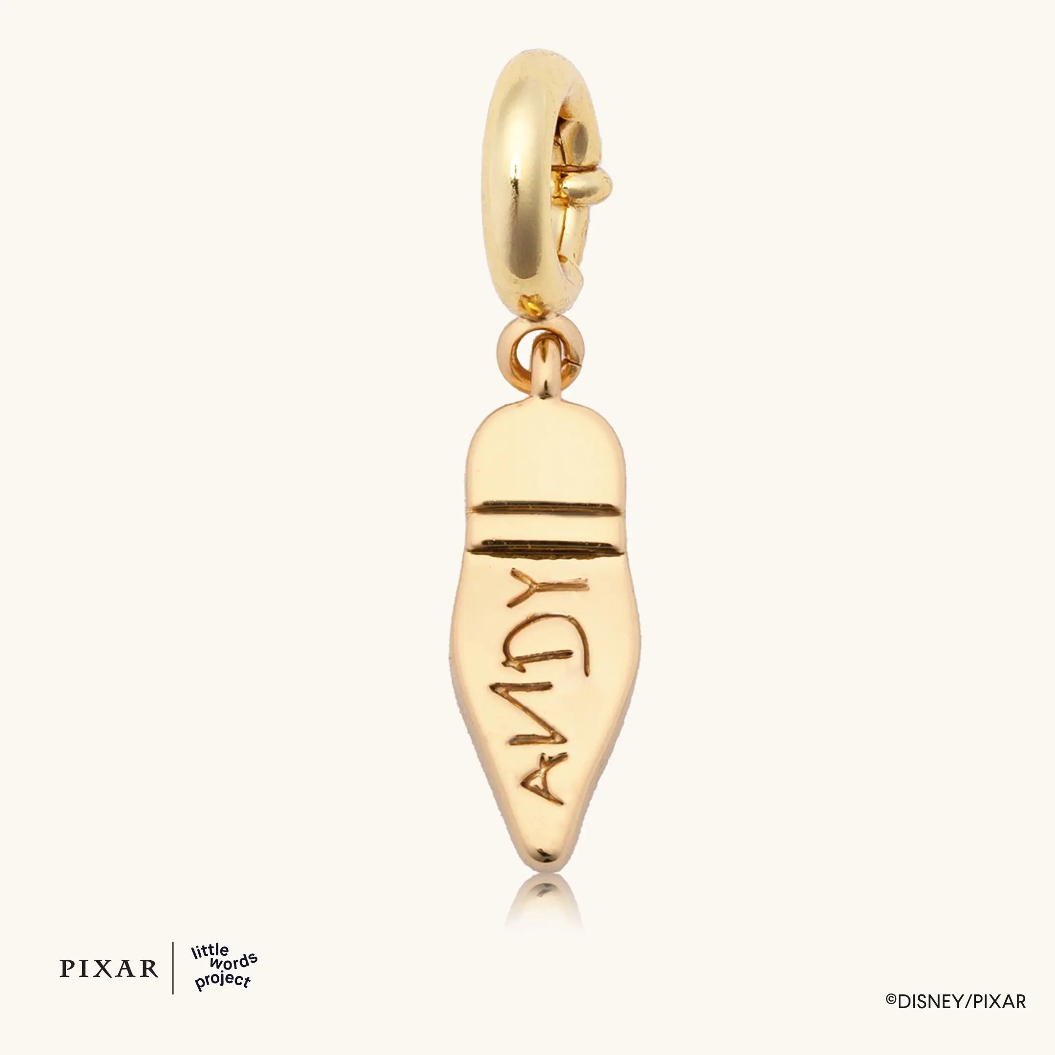 Woody's Boot Charm, gold Toy Story boot charm engraved ANDY on the sole, flat lay