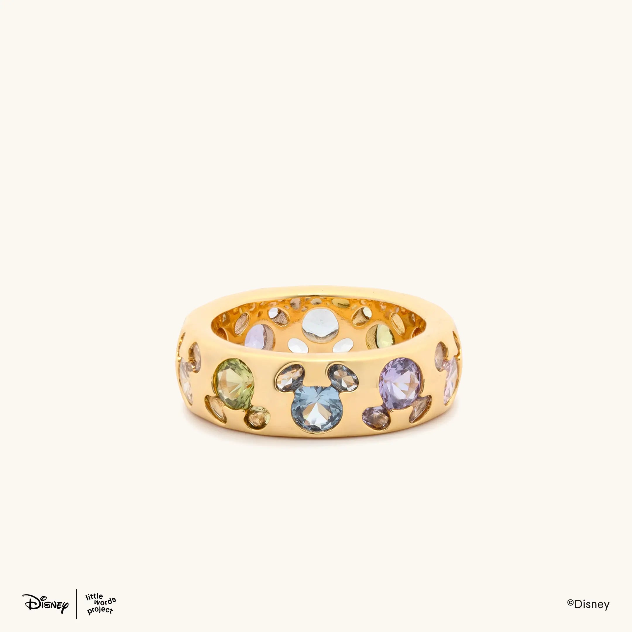 Mickey Mouse Rainbow Ring from Disney Mickey and Friends, gold plated band set with multicolor crystals, front view on cream