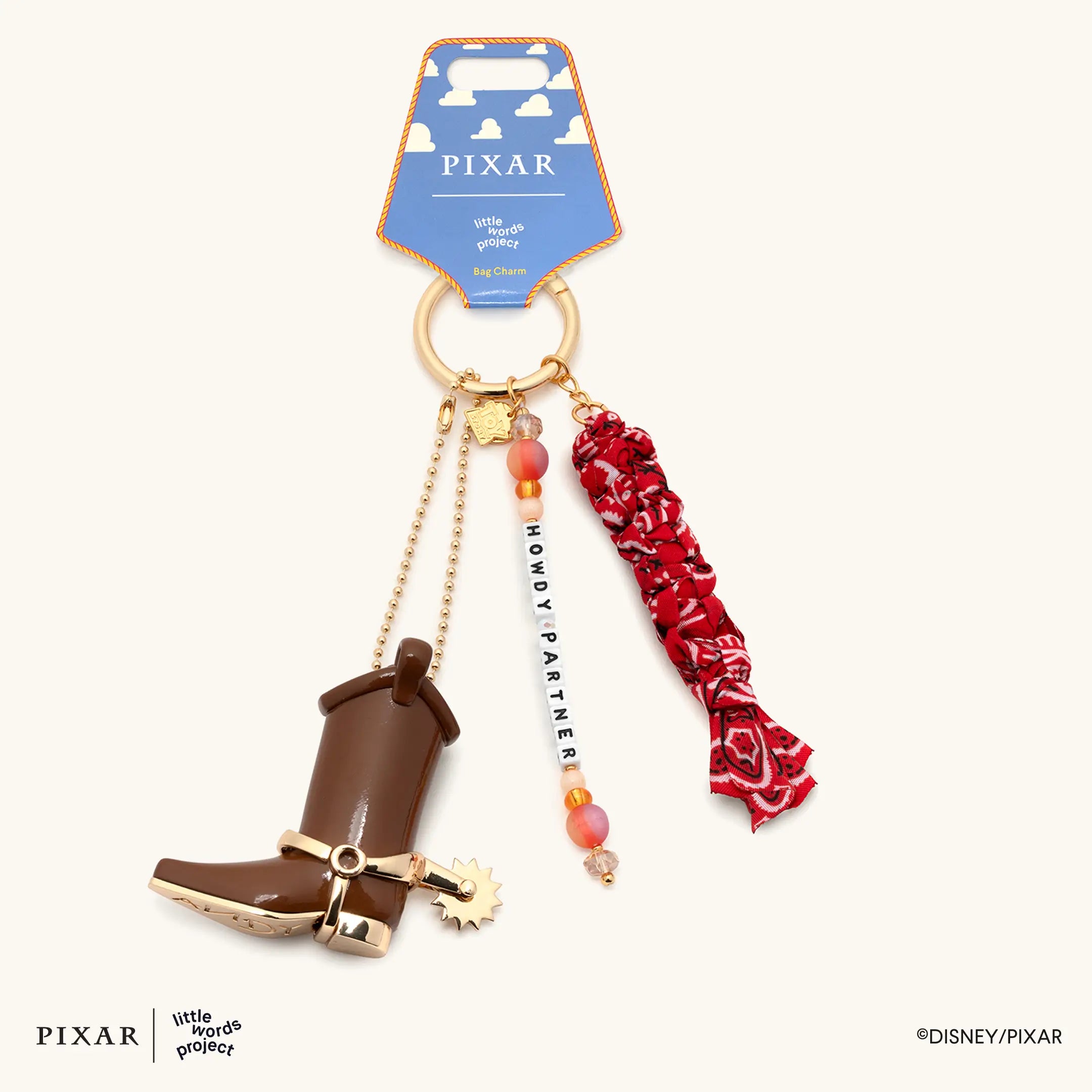 Howdy Partner Toy Story bag charm with boot, bandana and beaded strand hanging from a branded pouch