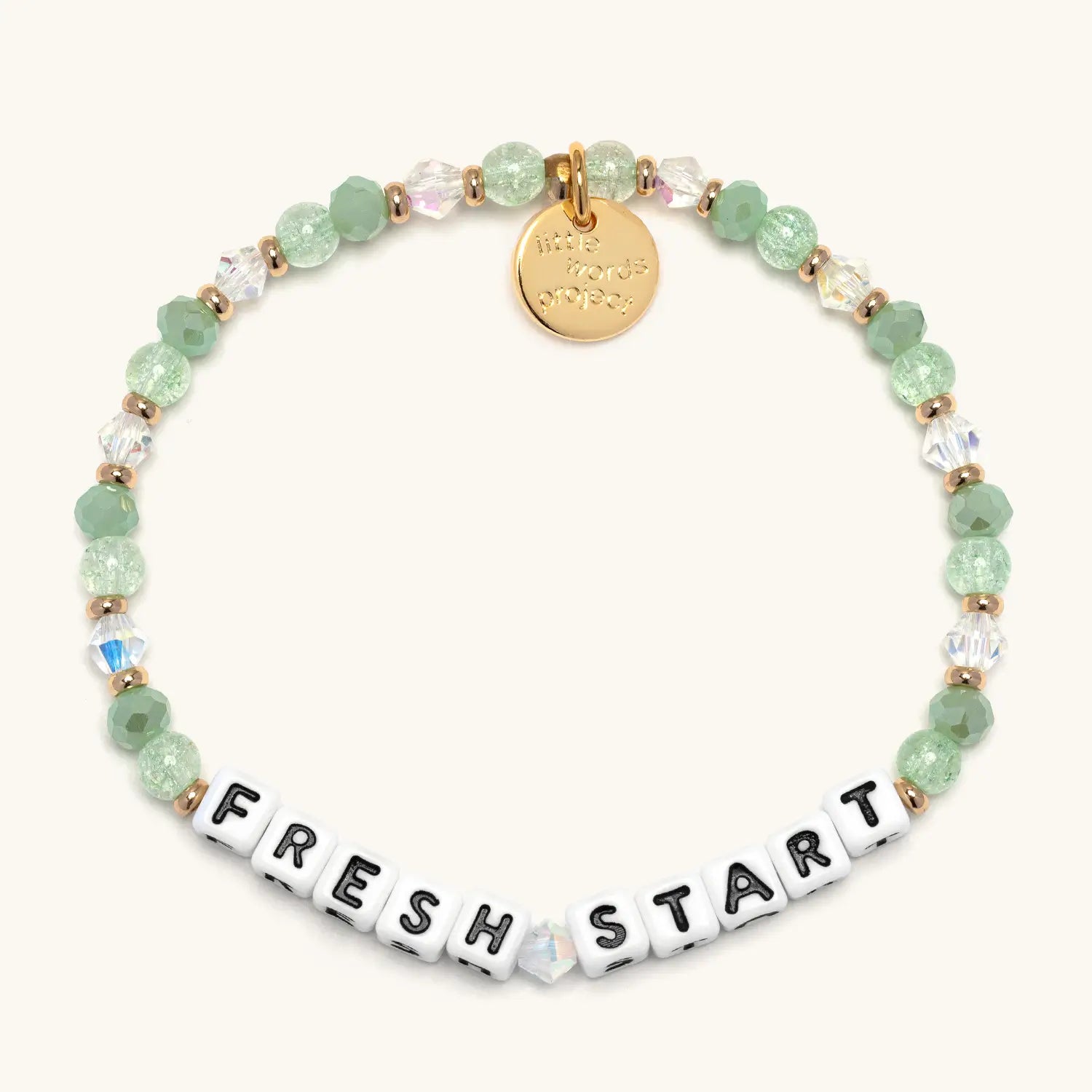 Bracelet with green beads and 'FRESH START' charm on a white background