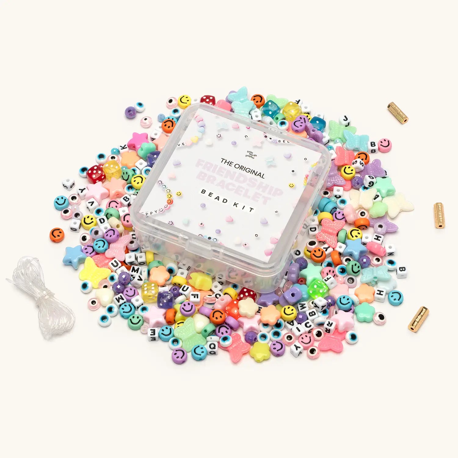 Original Friendship Bracelet Bead Kit with rainbow novelty beads spilled around clear storage box
