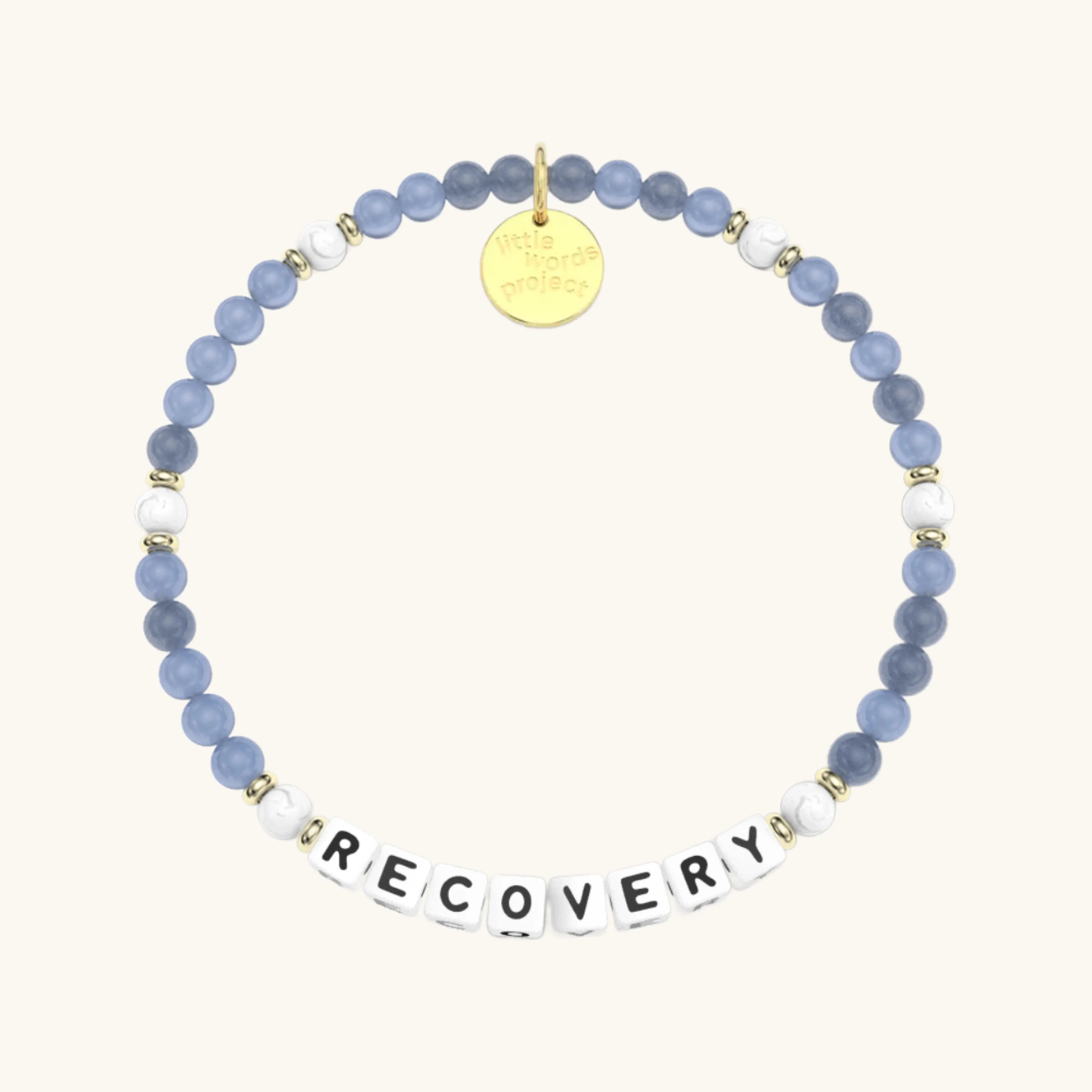 Bracelet with blue beads and a gold tag on a white background