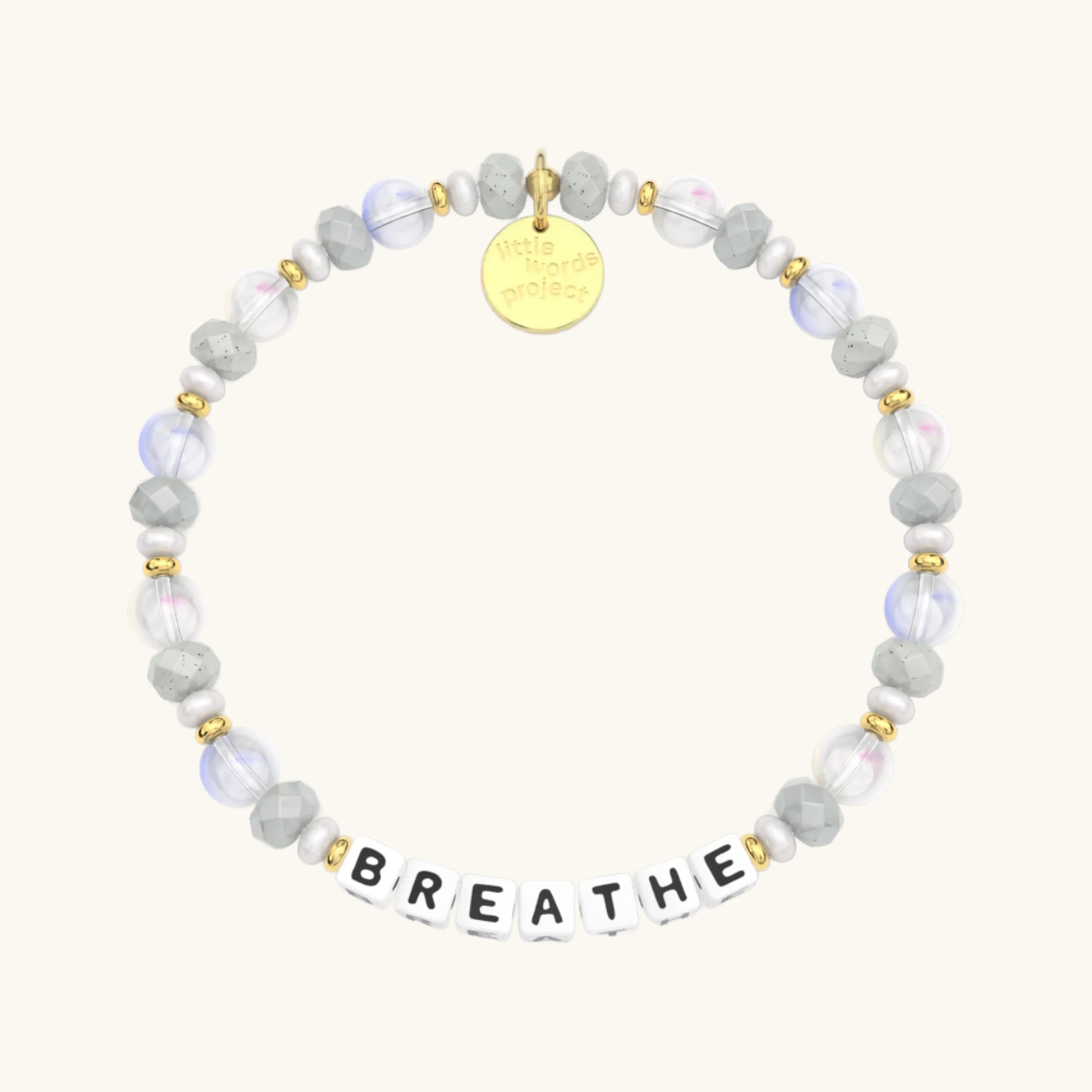 Bracelet with beads and a gold tag on a white background