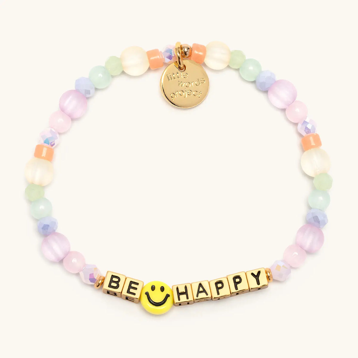 Be Happy bracelet with gold letter beads from the Good as Gold Bracelet Set, flat-lay on cream background