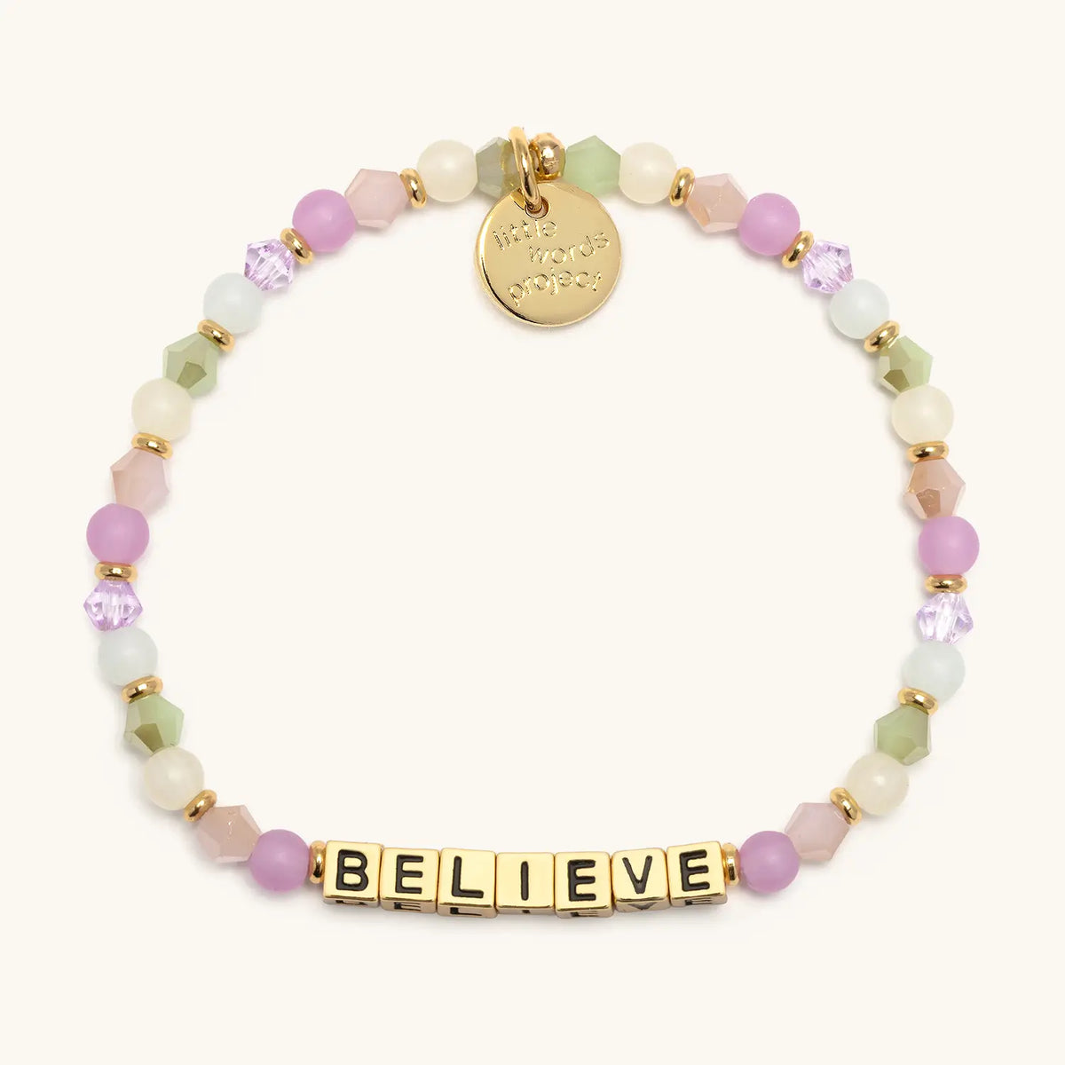 Believe bracelet with gold letter beads from the Good Things Ahead Bracelet Set, flat-lay on cream background