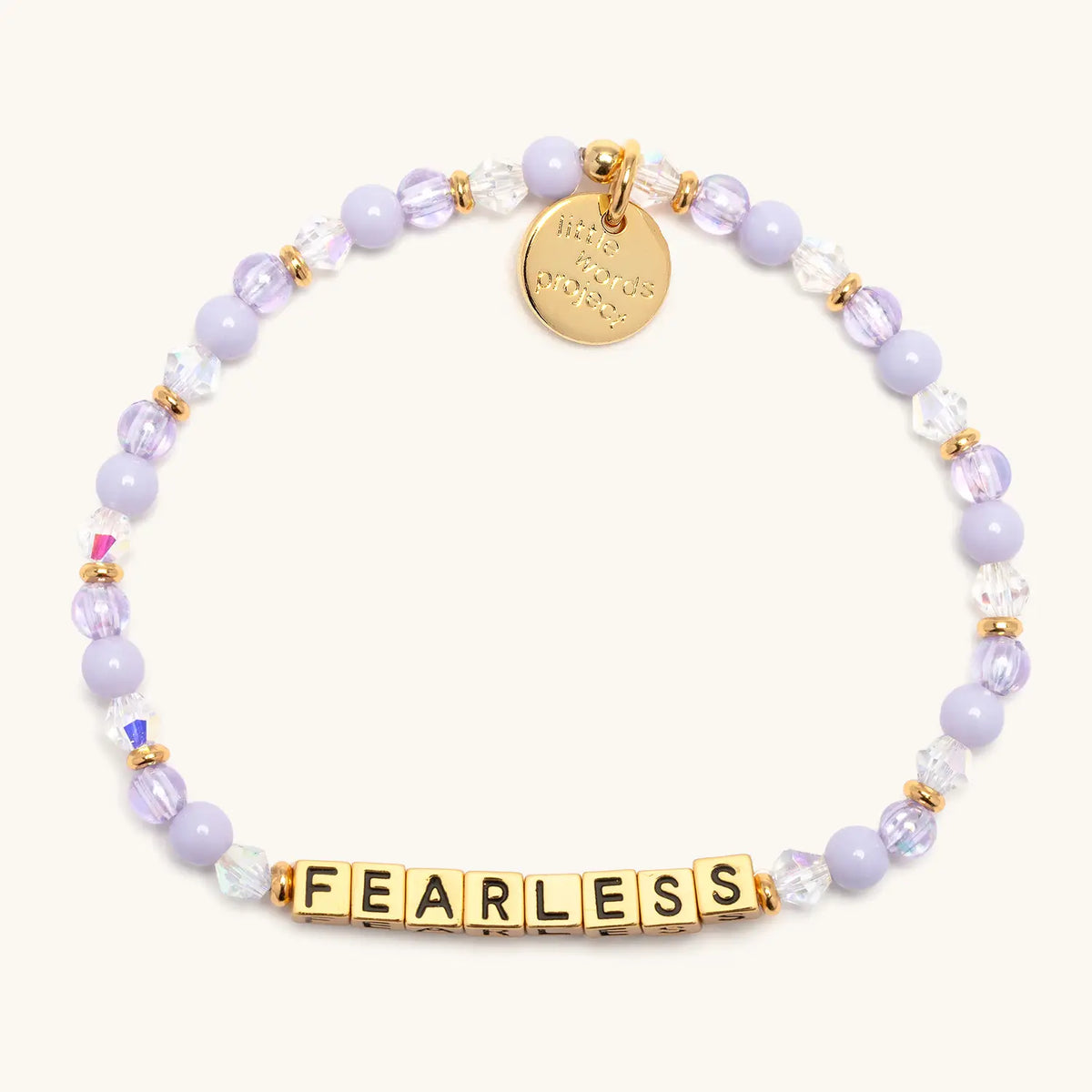 Fearless bracelet with gold letter beads from the Soft & Strong Bracelet Set, flat-lay on cream background
