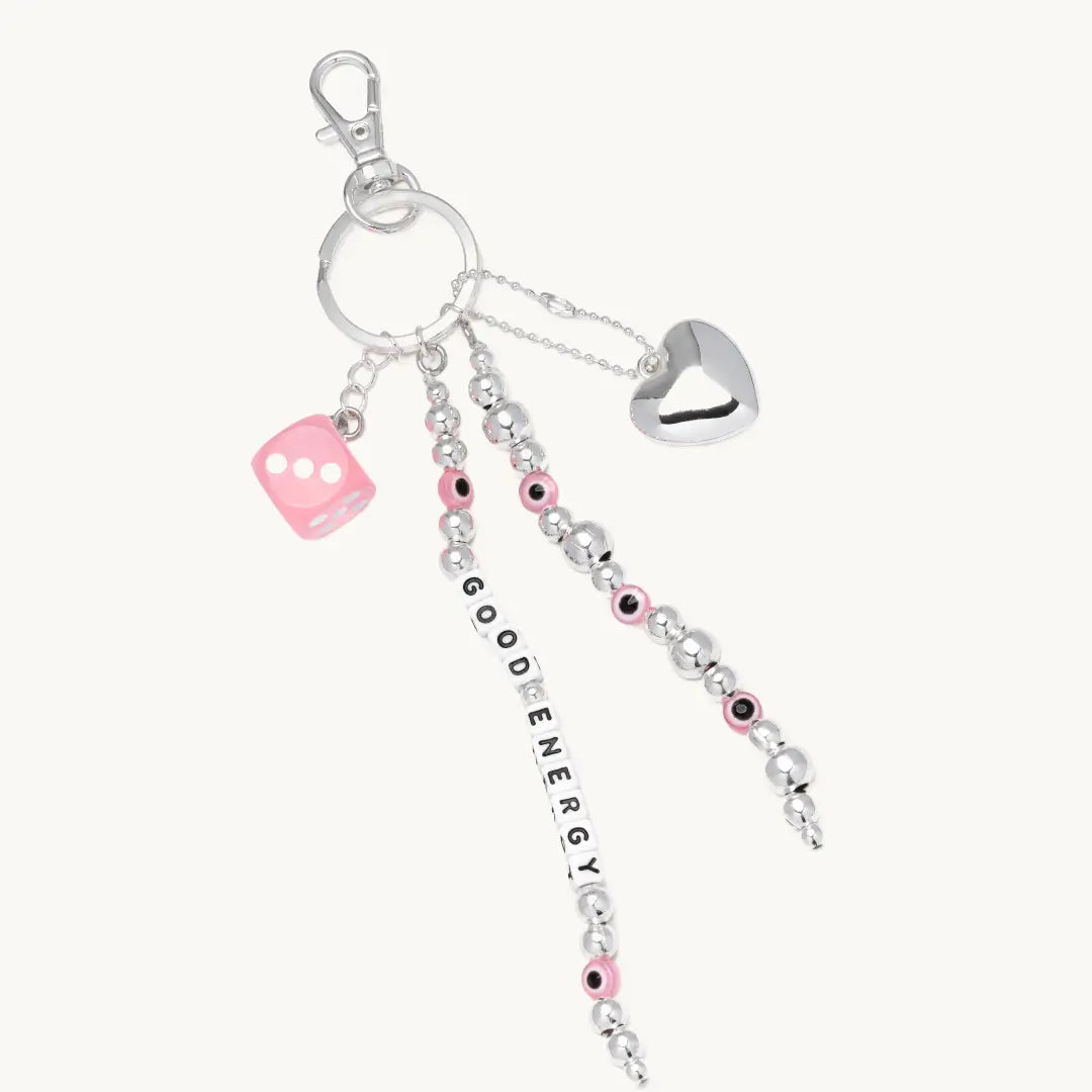 Bag Charm with heart, dice, and 'Good Energy' on a white background