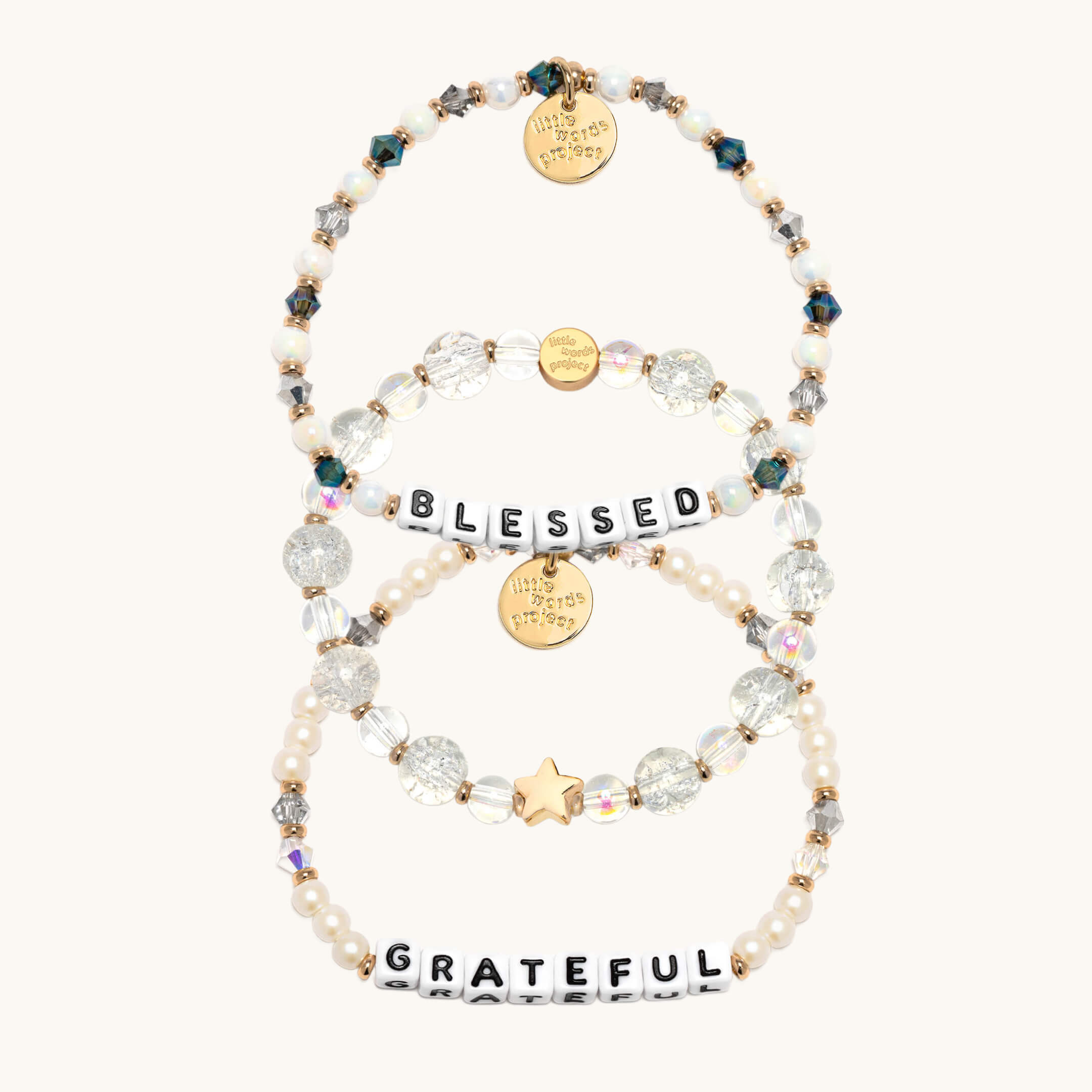 Set of beaded bracelets with 'Blessed' and 'Grateful' charms on a white background