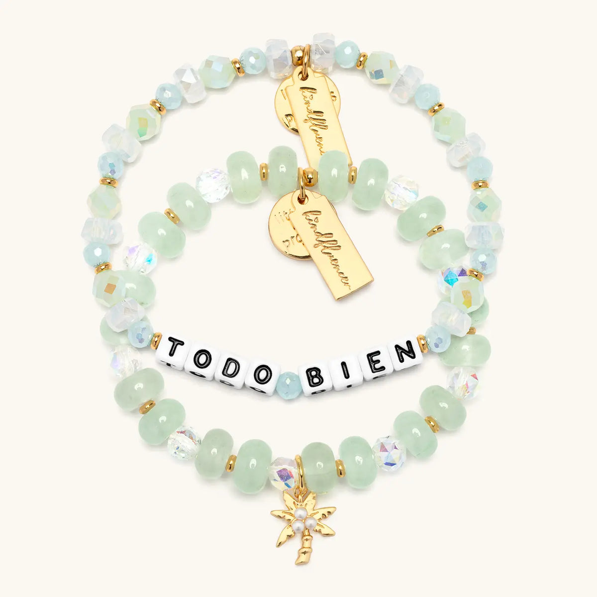 Todo Bien Bracelet Set Alexia Del Valle flat lay, Todo Bien bracelet and Palm Tree Charm Bracelet stacked in mint green, white, and clear beads