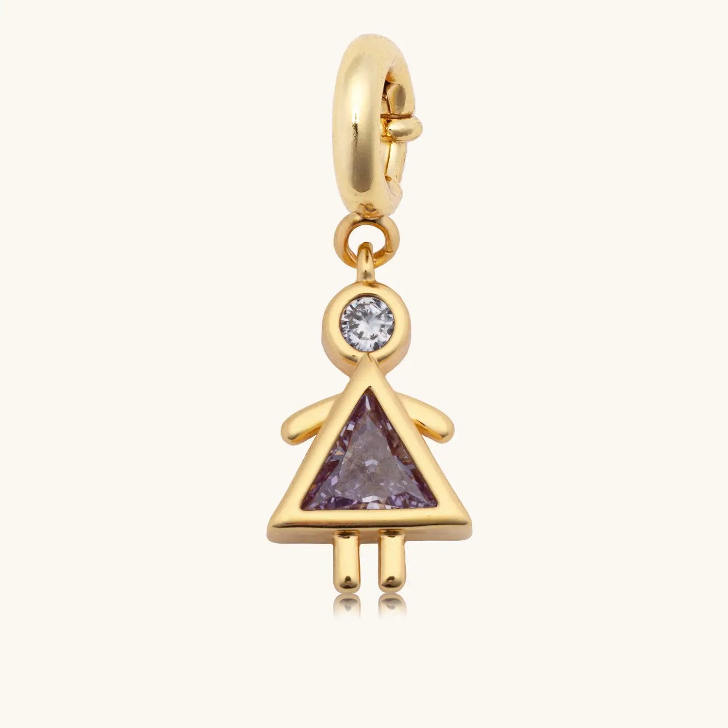 A gold dangle charm in the shape of a girl figure, featuring a round clear gemstone as the head and a triangular purple gemstone as the body forming a dress silhouette, with gold arms and legs, attached to a gold spring-ring clasp.