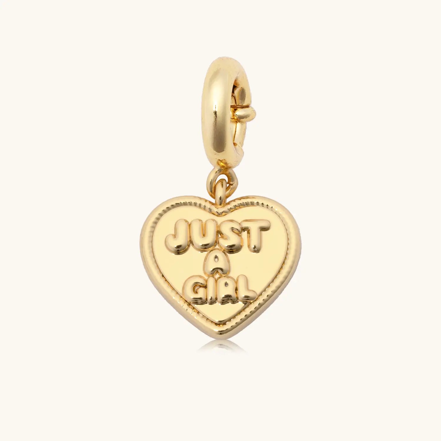 Just A Girl gold plated heart charm, flat lay