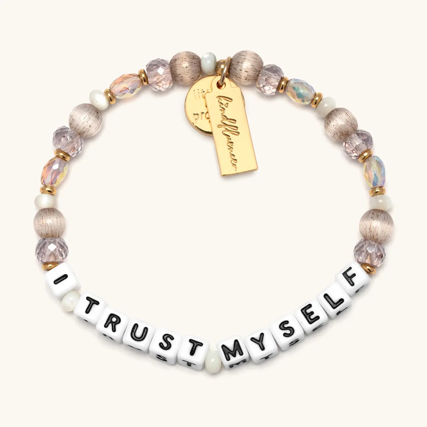 I Trust Myself Tori Deal Kindfluencer bracelet on cream, white letter beads with blush and iridescent crystals, champagne beads and gold charm tag