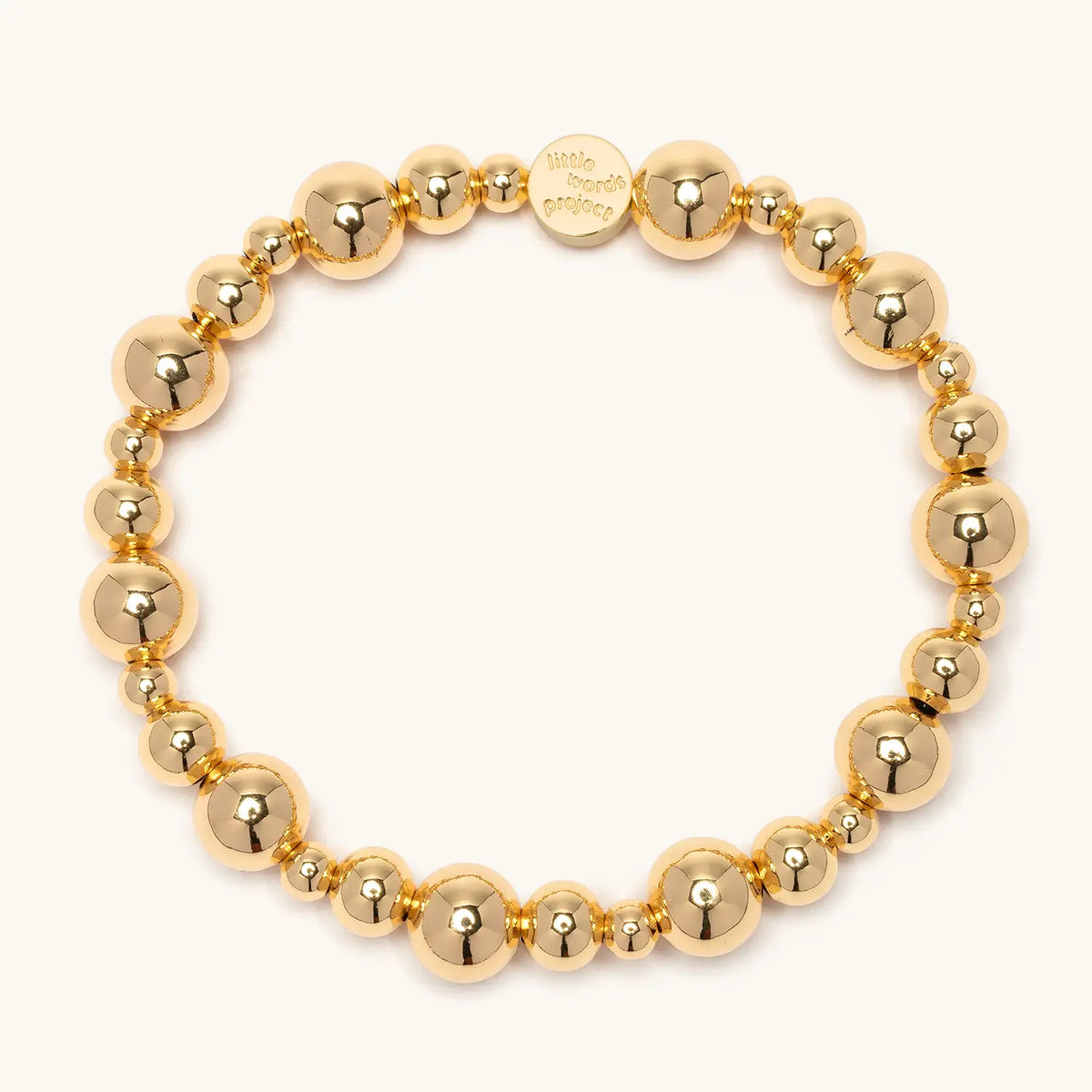 Gold Bubbles bracelet base, gold plated brass beads in alternating sizes with a gold Little Words Project logo tag