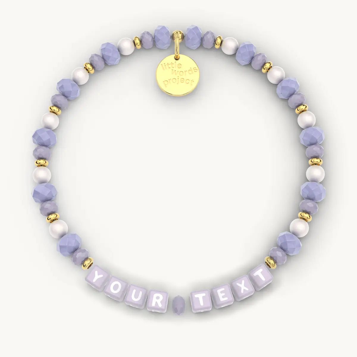 Personalized beaded bracelet with a gold tag on a white background