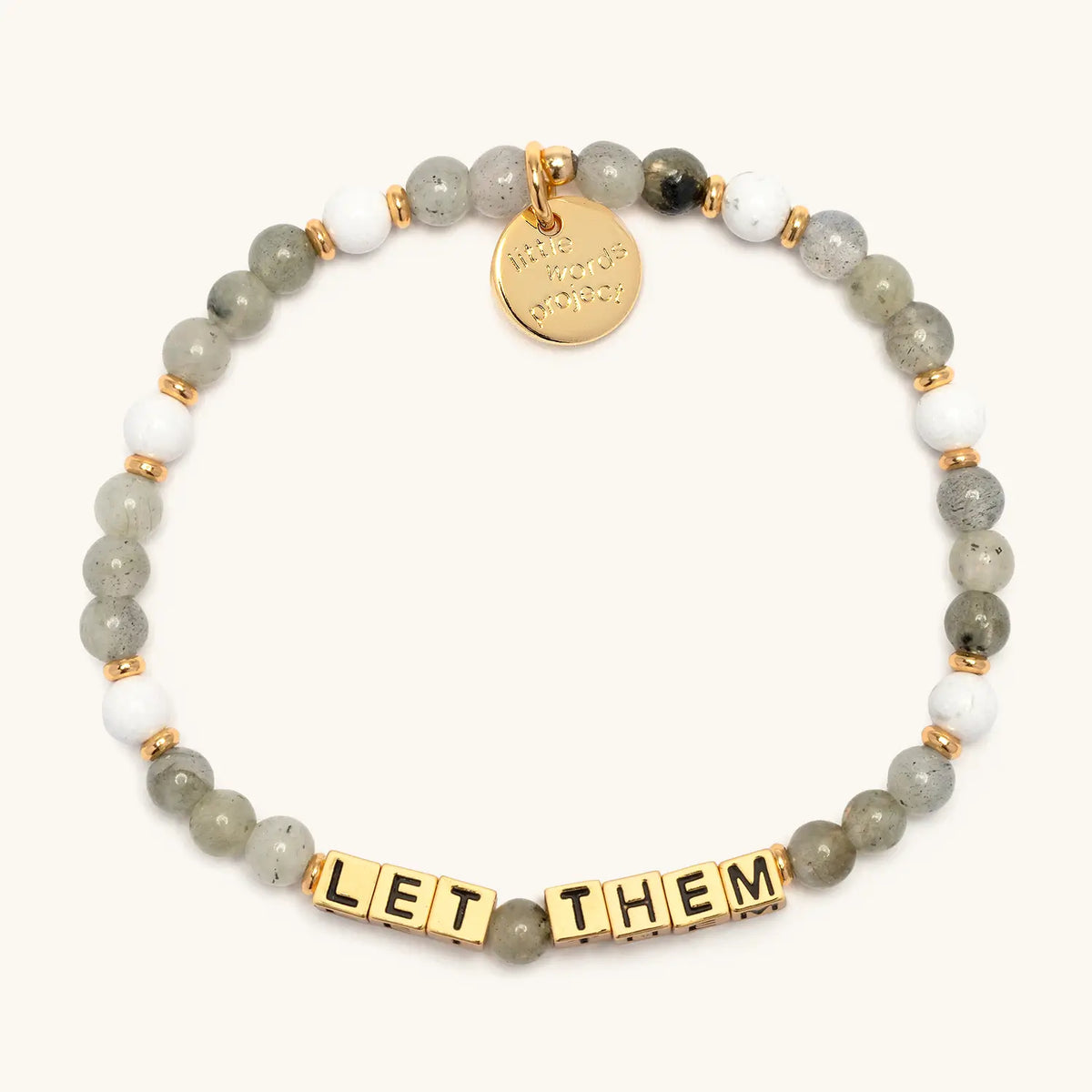 Let Them bracelet with gold letter beads from The Reset Bracelet Set, flat-lay on cream background