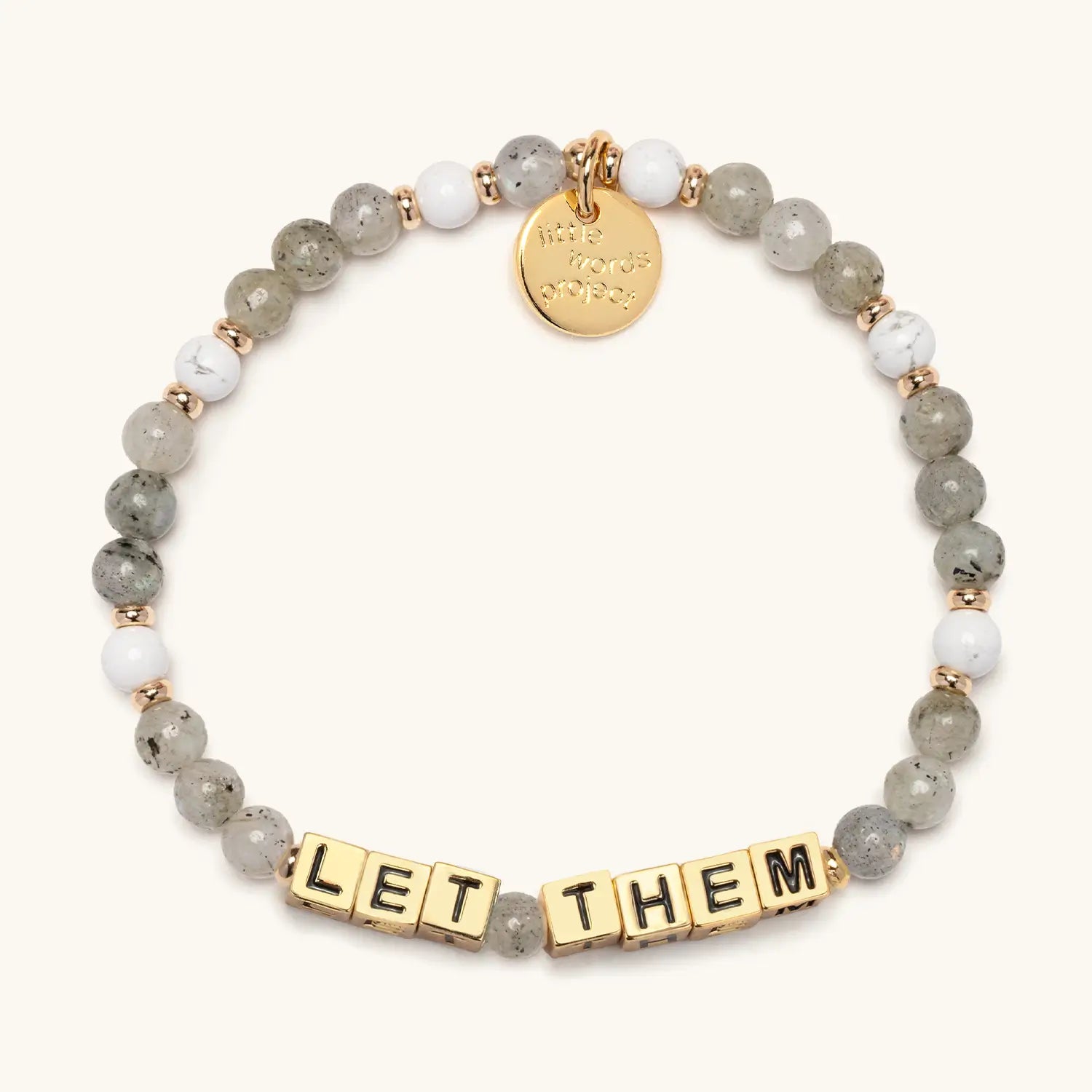 Bracelet with beads and gold tag on a white background