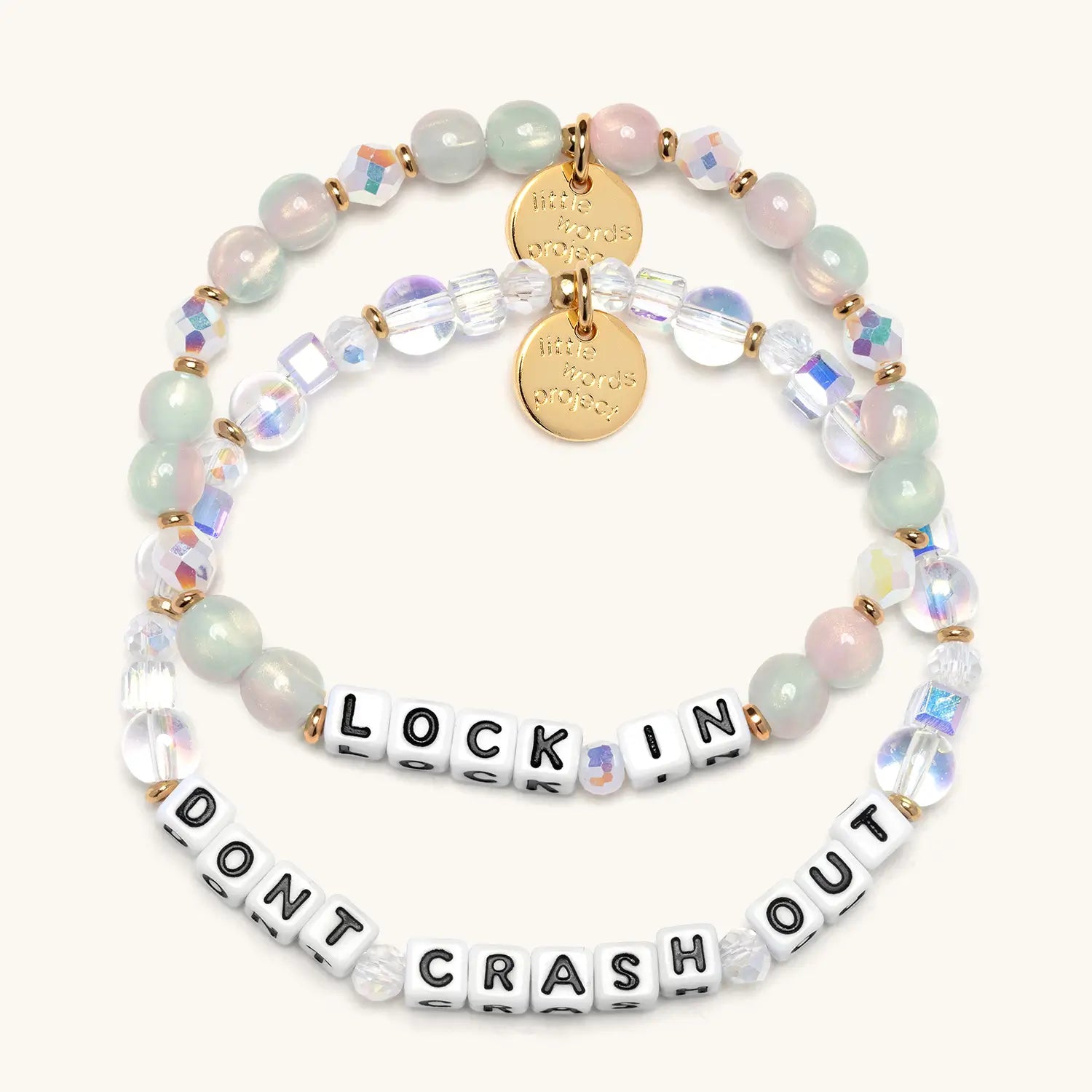 Two beaded bracelets with motivational phrases on a white background