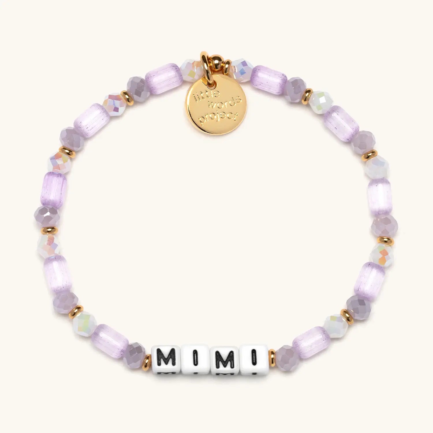 Bracelet with purple beads and a gold tag on a white background