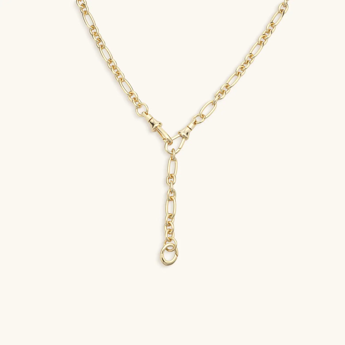 Lariat Convertible Necklace detail, 16k gold-plated mixed link chain with the Y-drop and clasp ring for adding charms, on cream background