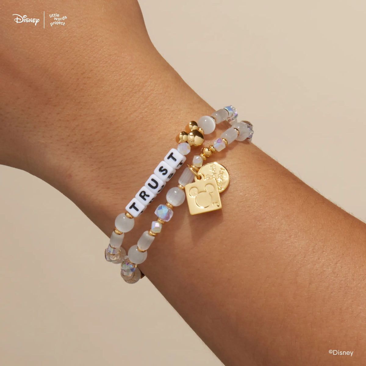 Mickey Custom Magic Maker Disney Mickey & Friends custom bracelets stacked on wrist, showing the gold Little Words Project and Mickey Mouse logo tags