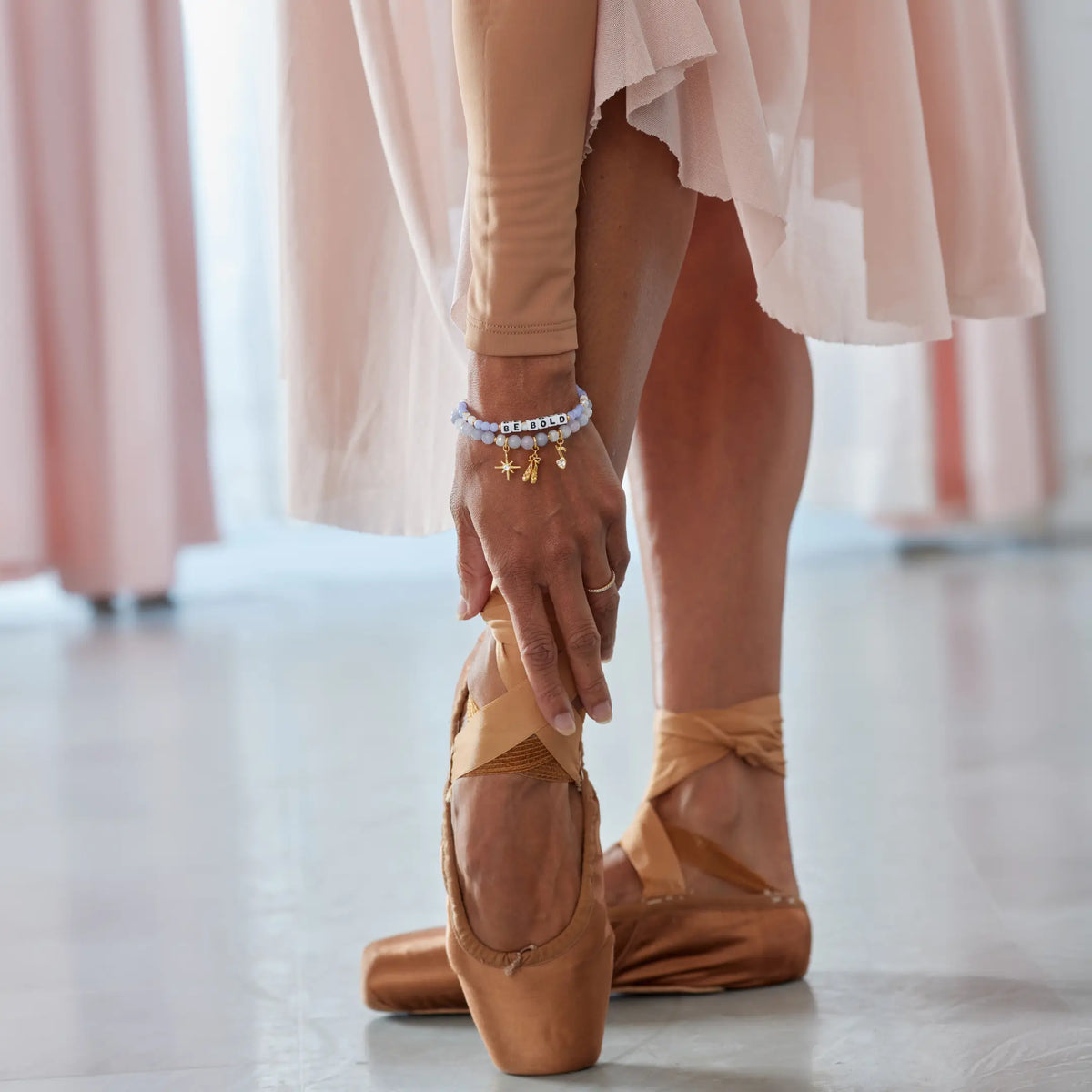 Bracelets worn while tying a pointe shoe ribbon