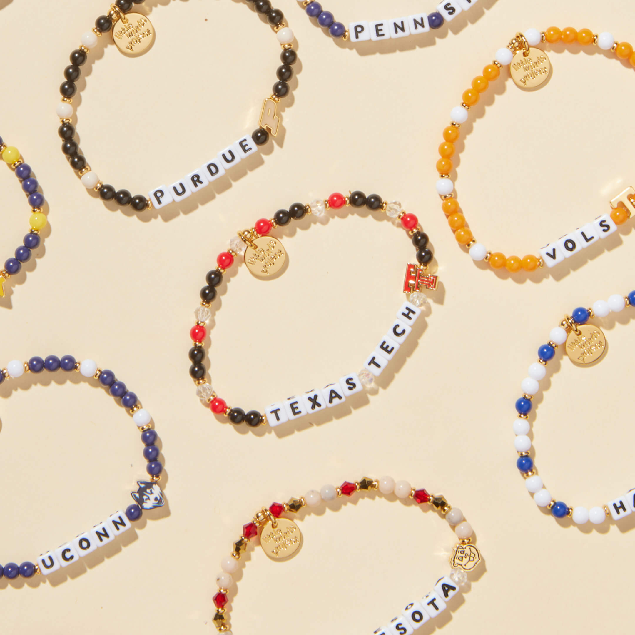Collection of beaded bracelets with various names on a beige background