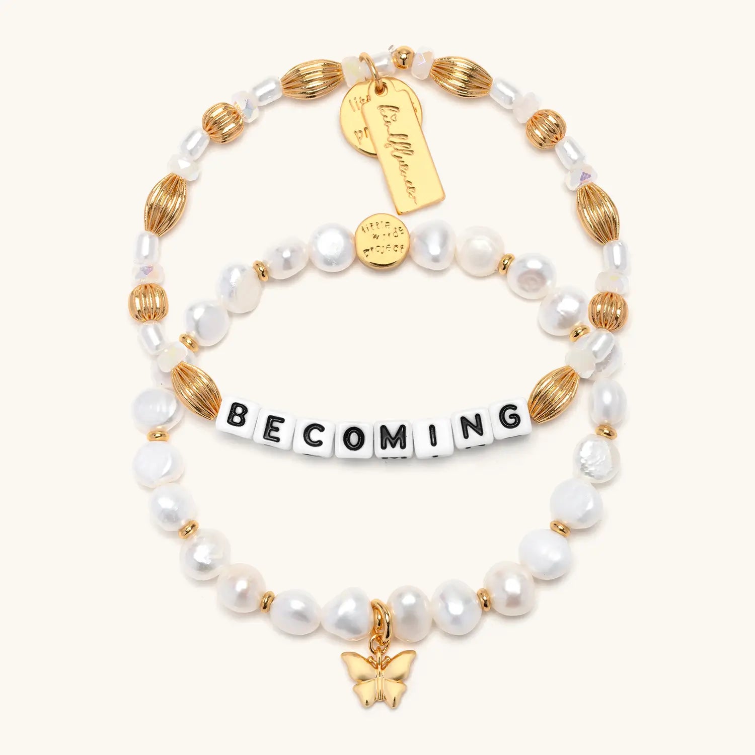 Becoming Bracelet Set- Nika Diwa flat-lay, both bracelets stacked showing Becoming word bracelet and Butterfly Pearl Bracelet Base together