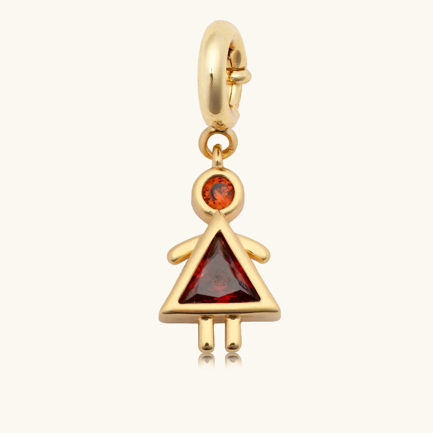 Charm with a red gem body and girl in a dress shape against a white background